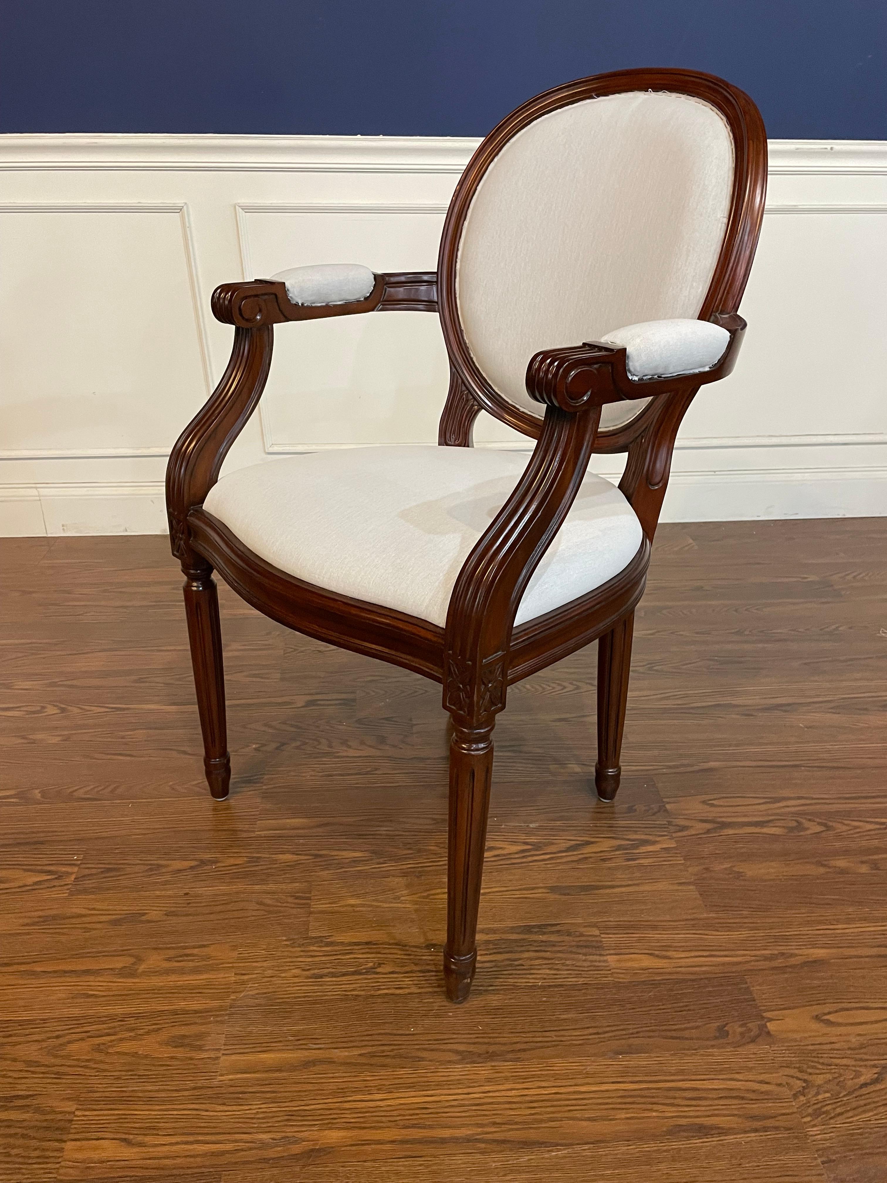 This is a set of eight (2 arms and 6 sides) of Louis XVI style mahogany dining chairs by Leighton Hall.  They have classic round backs and round fluted and tapered legs. They have a medium brown mahogany color with a satin/semigloss sheen.  They