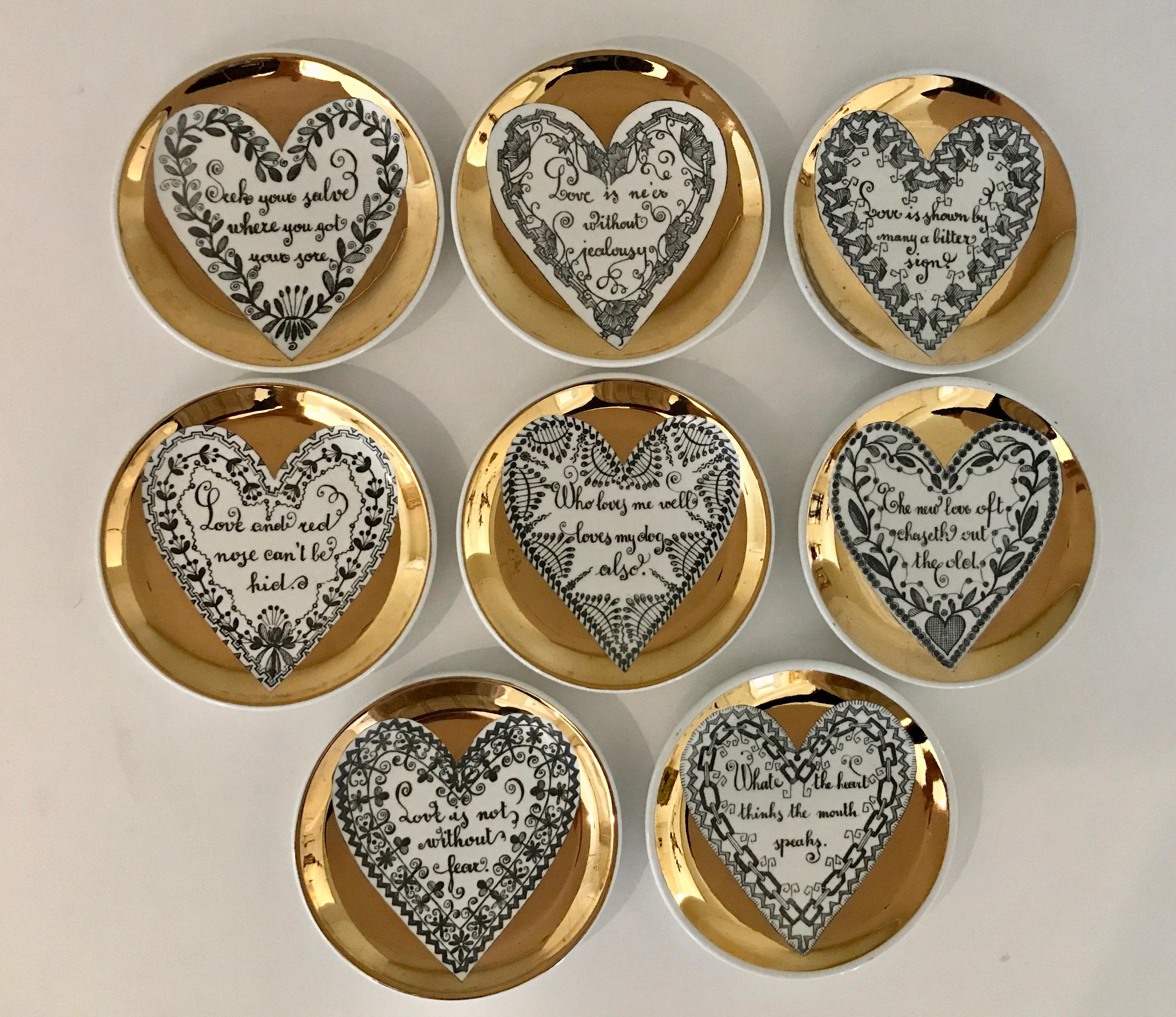 A full set of 8 LOVE series coasters by Piero Fornasetti. Each coaster has a gold border surrounding a heart with its own unique motif surrounding a different saying or proverb. This series was not produced in large numbers and full sets are more