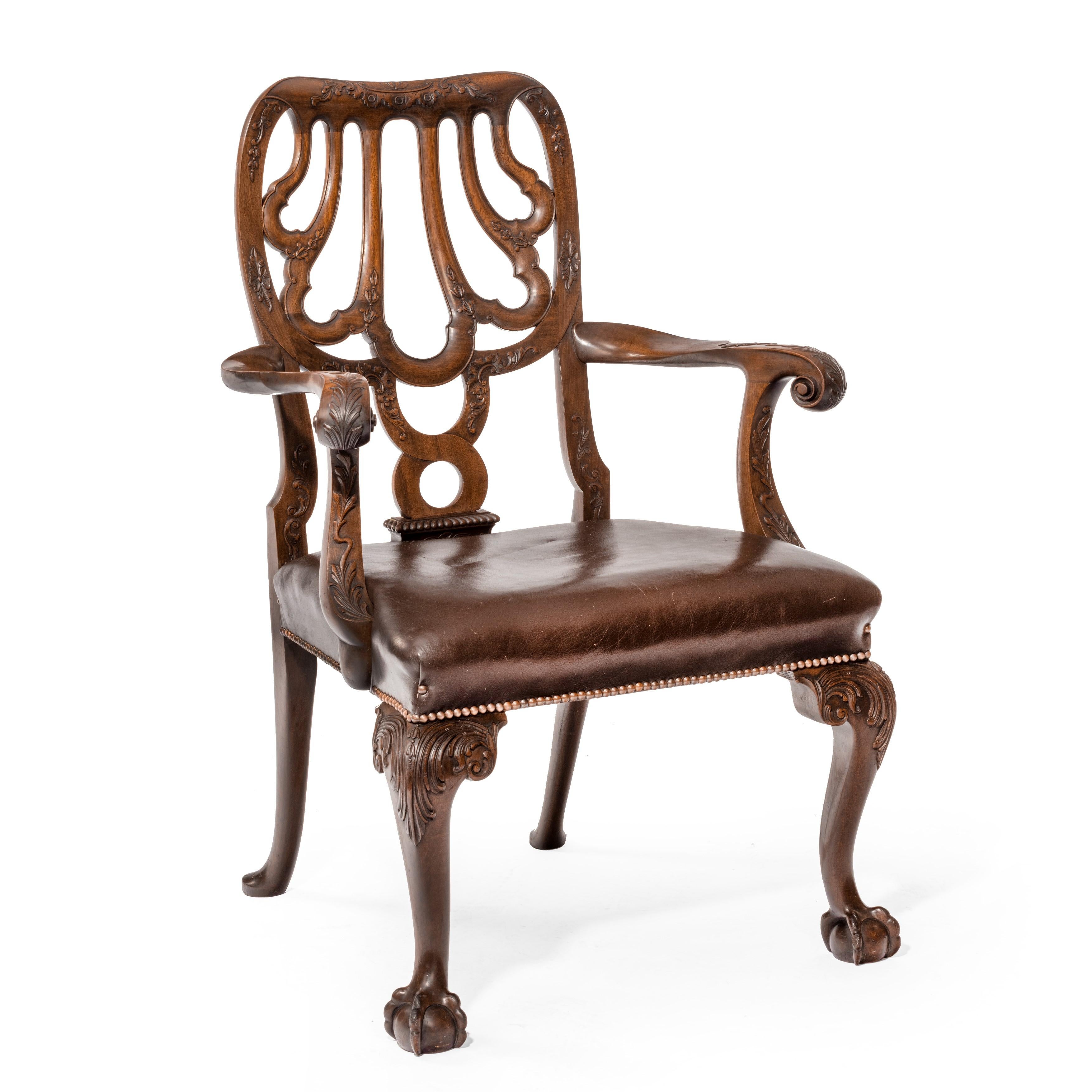 A set of eight mahogany dining chairs by Marsh, Jones and Cribb, in the style of the Grendey chairs at Stourhead, comprising six side chairs and two carvers, the carvers each with strap work scallop backs, scroll arms, acanthus carved cabriole front