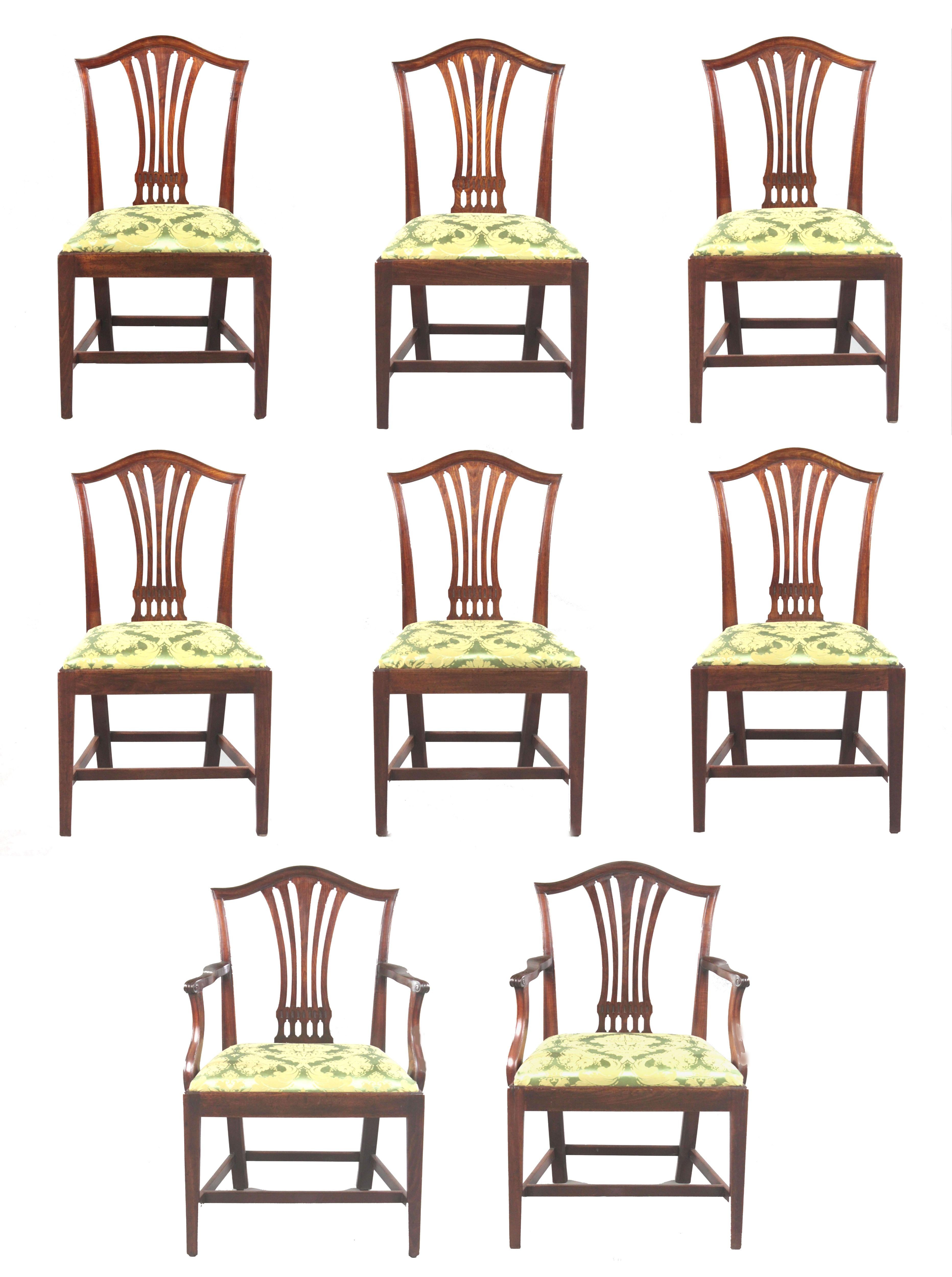 A set of 8 George III Sheraton period dining chairs, two carvers and six singles in figured mahogany of a good nut brown colour and in good condition. The camel backs with attractive pierced splats, square tapered legs united by H-stretchers. The