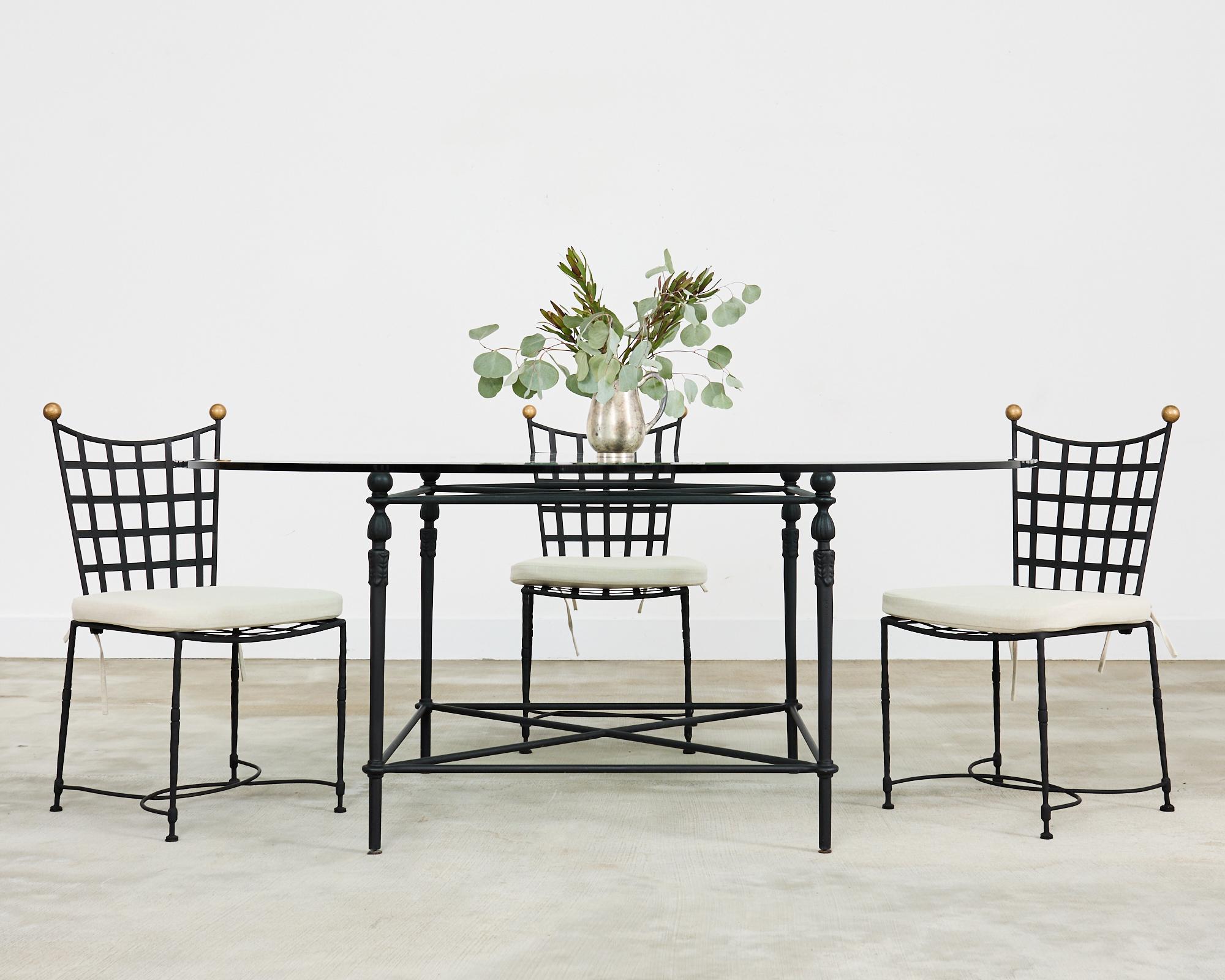 Dramatic set of eight wrought iron patio and garden dining chairs designed in Italy by Mario Papperzini for John Salterini. Hand-crafted in the neoclassical taste with geometric lattice seats and backs. The frames have a hand-hammered finish with a