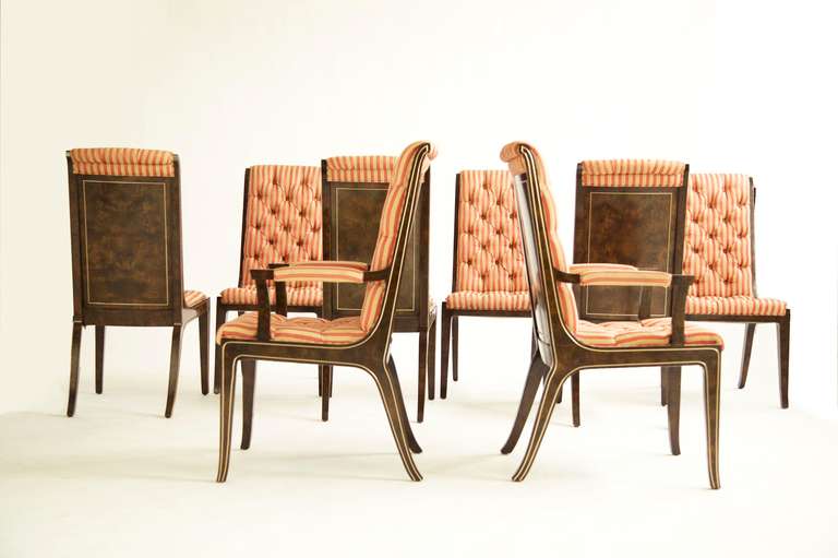 Mastercraft dining chairs for Widdicomb, six side chairs with two armchairs.
Patched and bookmatched burled veneer, with extruded curved brass accents.
Tufted upholstery would benefit from recovering.