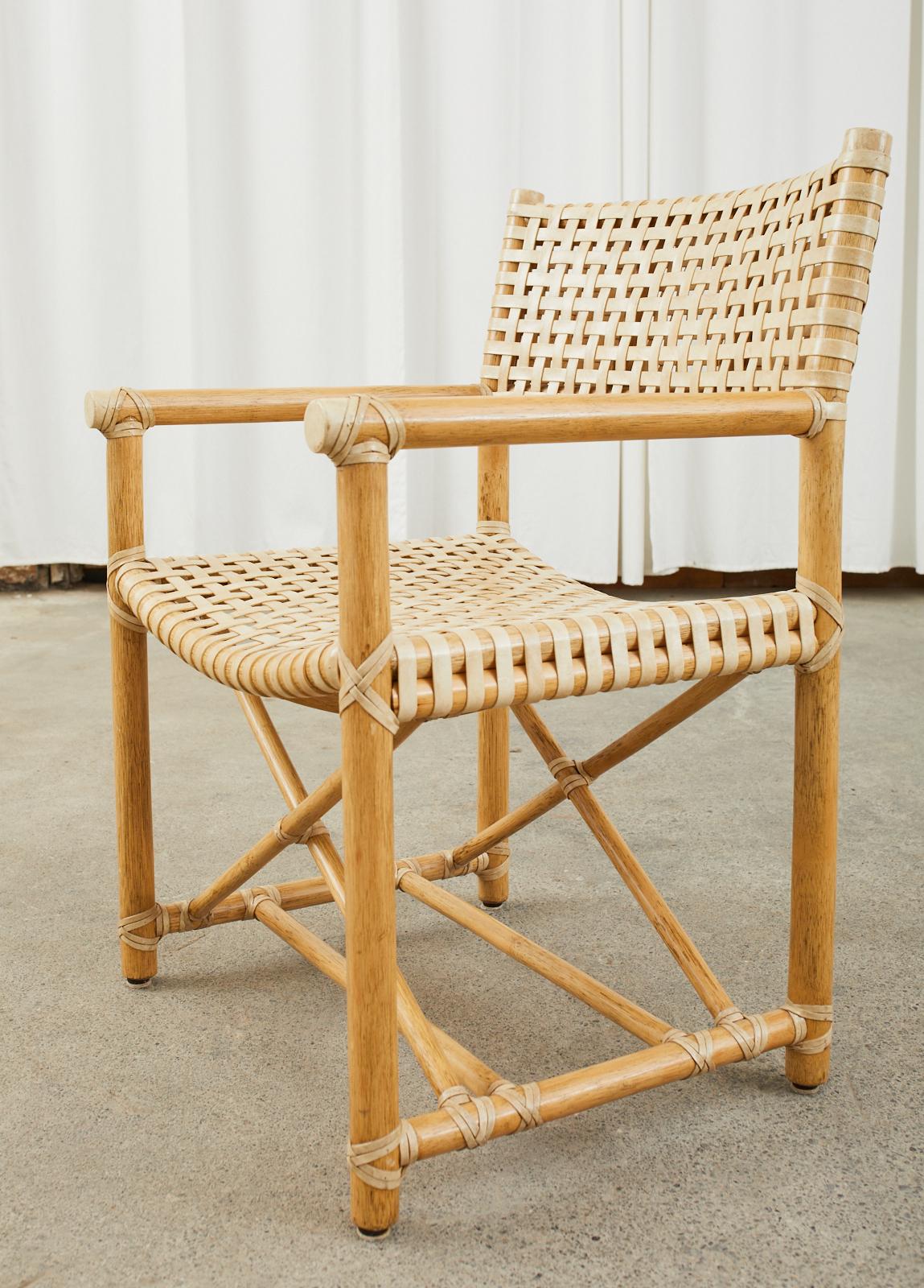 Genuine set of eight rare McGuire Antalya directors style dining armchairs featuring lattice style laced rawhide woven leather seats and backs. Model #MCLM45 constructed with rattan poles lashed together with leather rawhide laces on the exposed