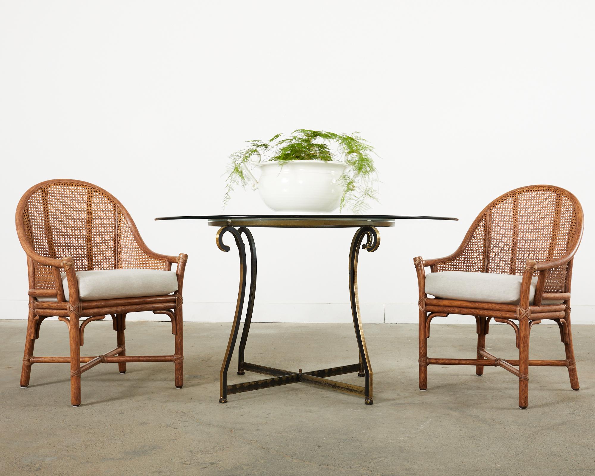 Gorgeous set of eight McGuire dining chairs known as Belden chairs. Made in the California coastal organic modern style featuring thick pole rattan frames with a barrel back form inset with honeycomb cane on the back and sides. The gracefully back
