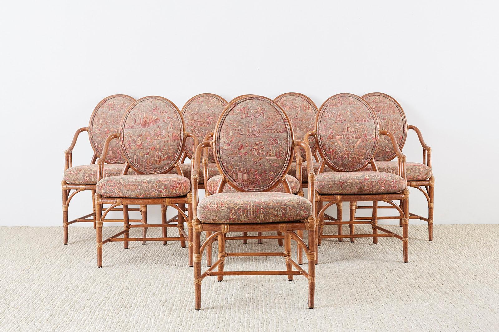 Fantastic set of eight organic modern dining armchairs made by McGuire. Constructed from bamboo rattan poles featuring caned seats and round backs. Upholstered with a vintage chinoiserie style fabric. The chinoiserie fabric is decorated with
