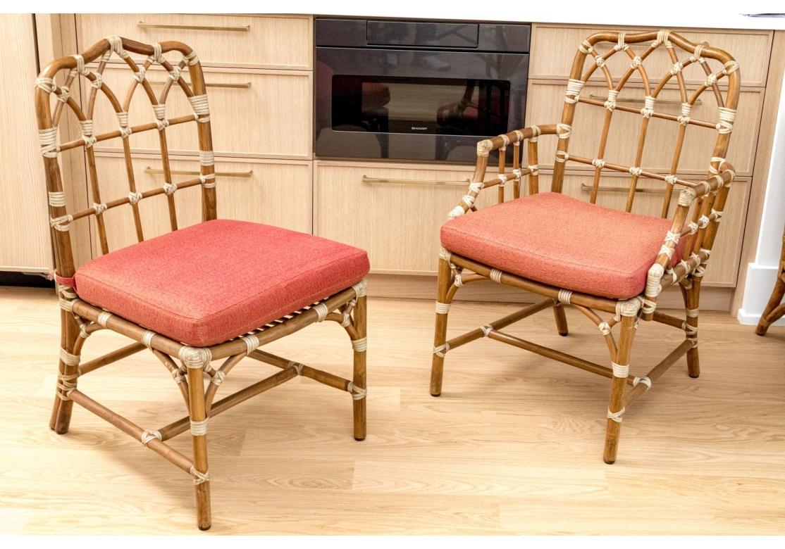 Classic McGuire leather wrapped Rattan Dining Chairs. The design with a nod to the Chippendale style while utilizing the natural materials of Rattan and Leather. Very well made and solid feeling with a bit of give to the backs for comfort. A set of