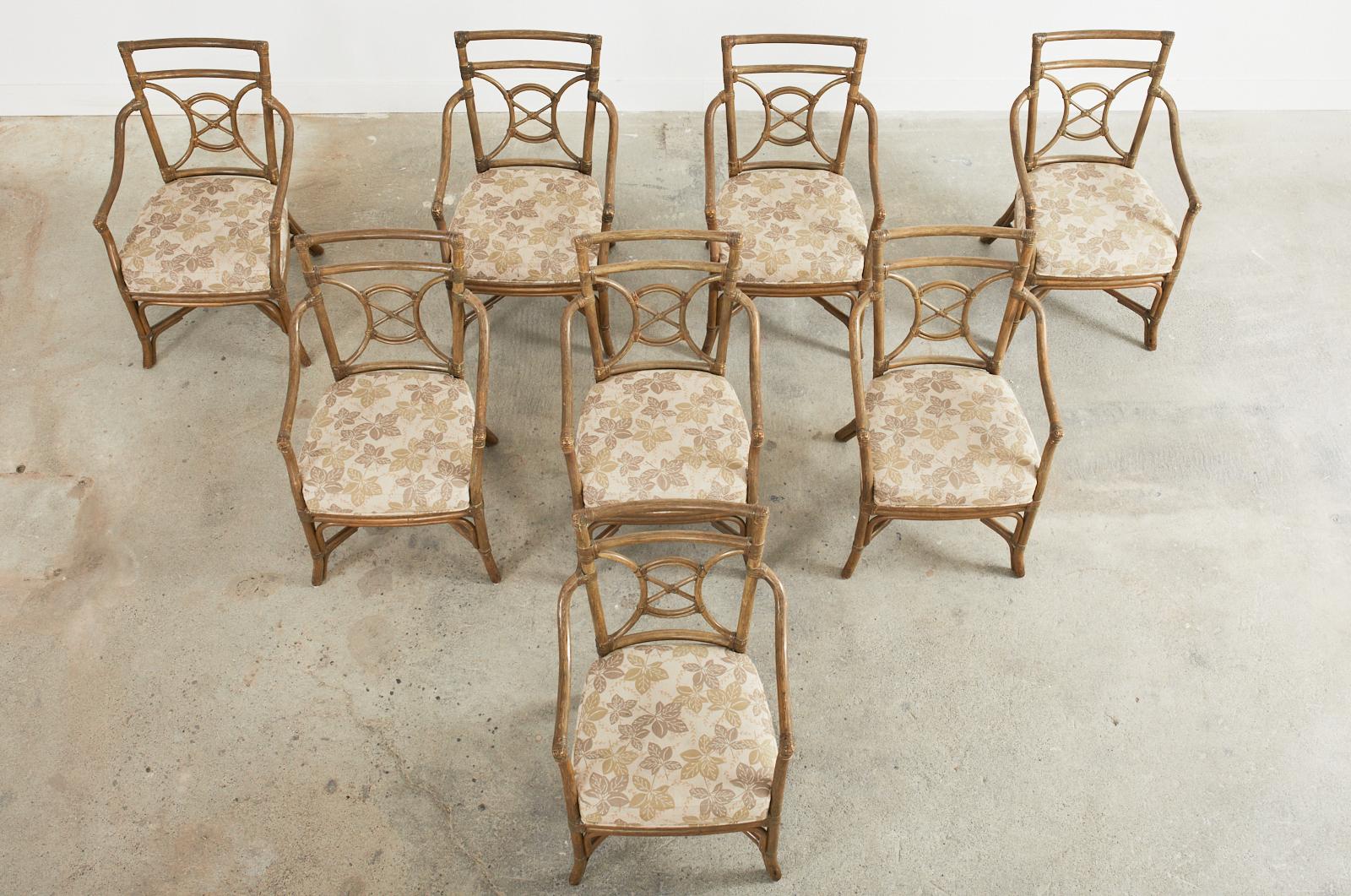 Organic modern set of eight rattan dining armchairs made in the style and manner of McGuire. Artisan crafted chairs constructed in San Francisco, CA featuring a target or bullseye motif back splat. Made from thick rattan poles lashed together with