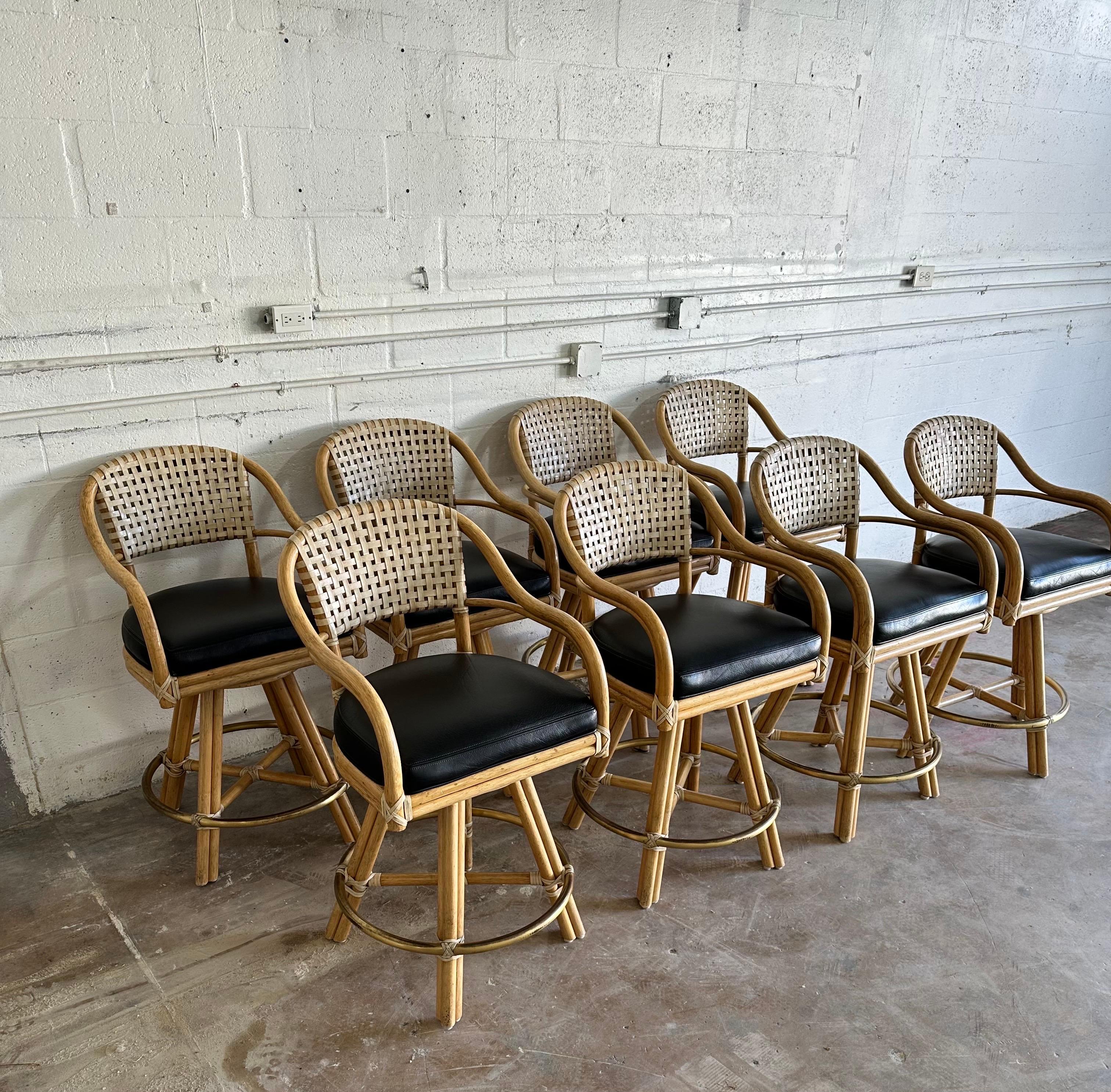 Exceptional set of eight  swiveling Bar stool signed McGuire , Rattan and faux leather .