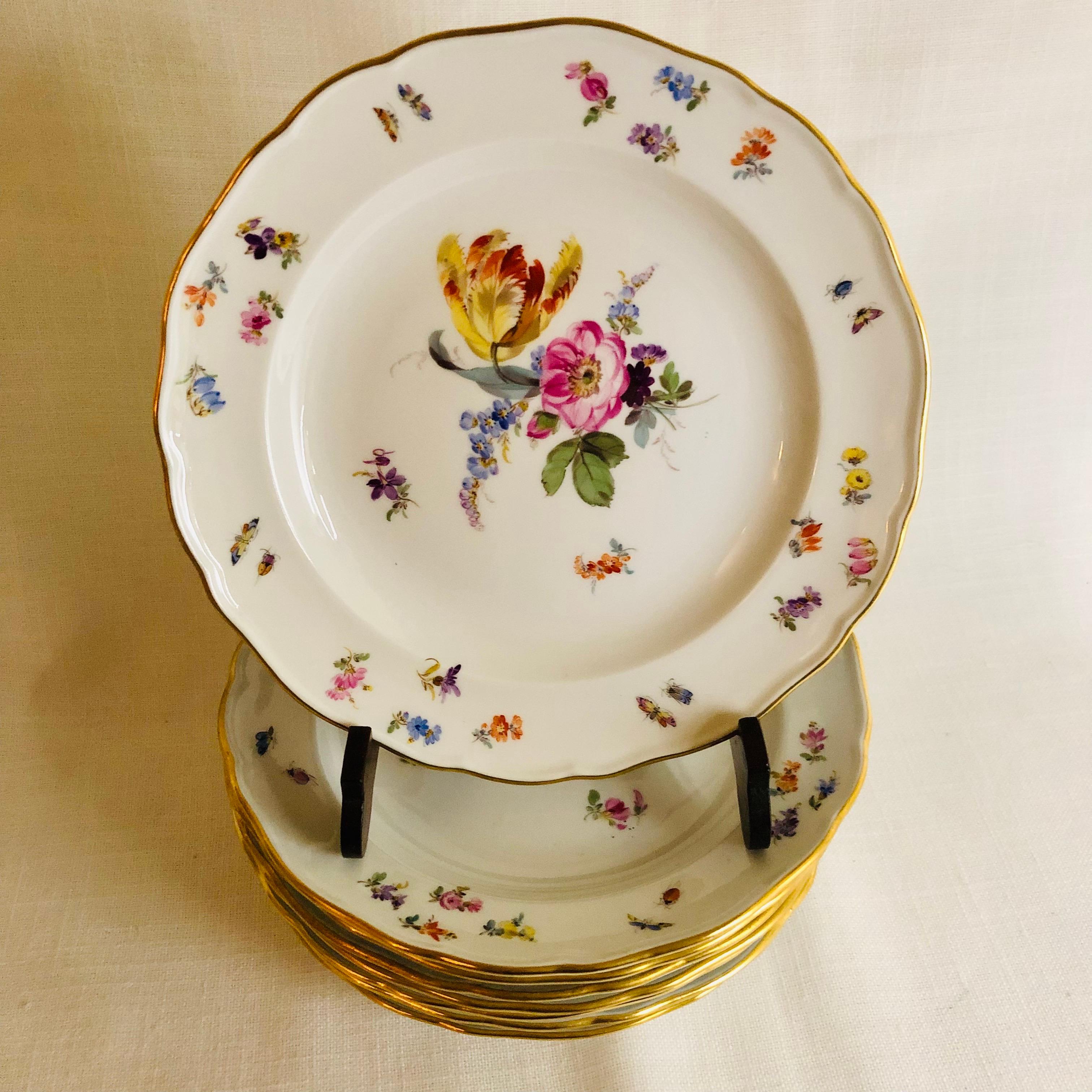 I want to offer you this beautiful set of eight Meissen dessert plates. Each plate is painted with a different central flower bouquet. Inside the gilded border of each plate are smaller flowers and insects as you can see on the attached photographs.