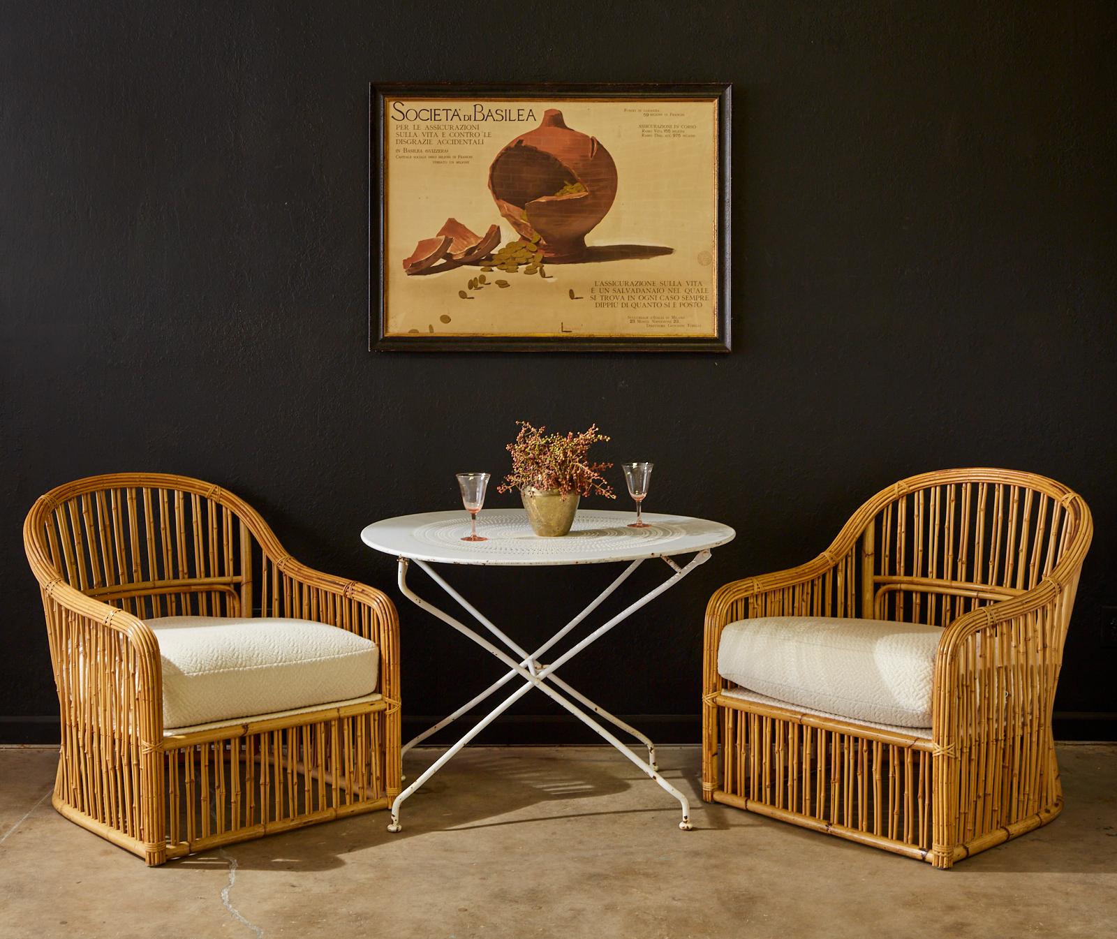 Stunning set of eight bamboo rattan lounge chairs made by Randolph and Hein San Francisco for Michael Taylor Interiors. The large armchairs feature a Classic barrel shaped frame crafted from bamboo poles and smaller bamboo reeds. The arms gracefully
