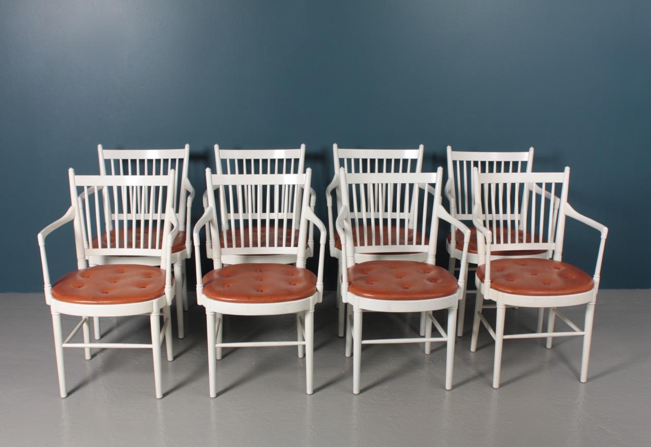 Set of eight armchairs with original white frame and patinated leather seats. Designed by Bjorn Wiinblad. Made in Sweden in the 1970s. Great condition.