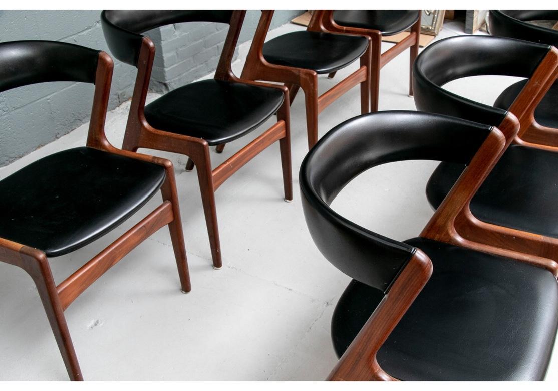A particularly fine set of circa 1960’s solid teak and black vinyl dining chairs by the iconic Danish designer Kai Kristiansen and unmistakably his Model 31 Chair. Very solid feeling and quite comfortable, the curved back provides the perfect