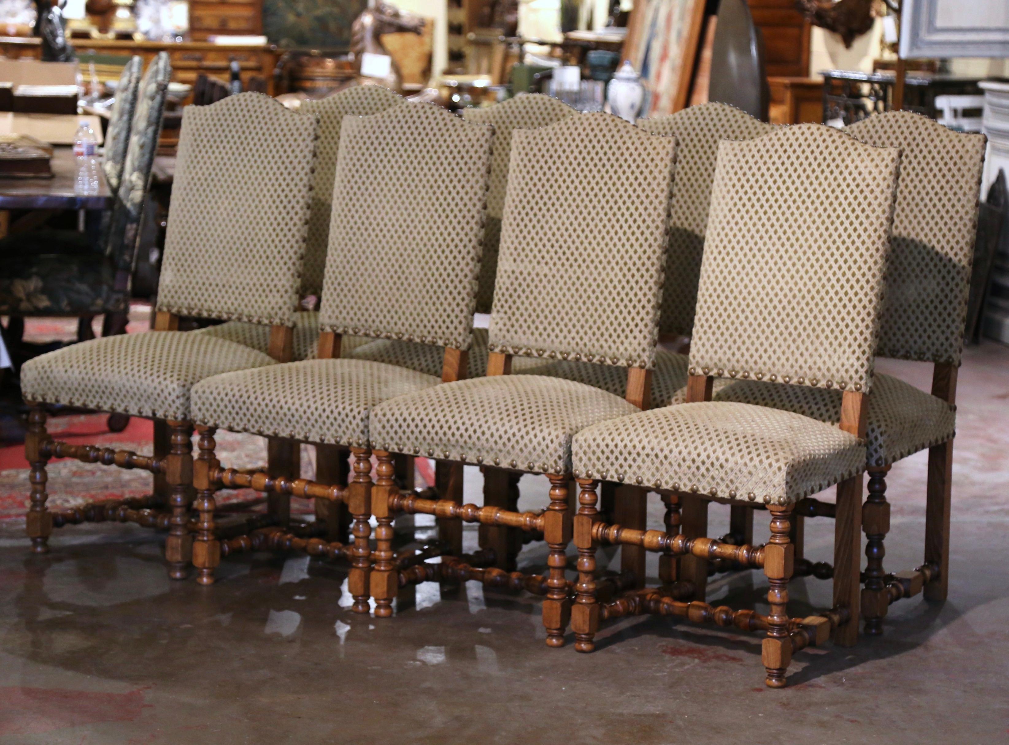 Dressed a breakfast or dining room with this elegant suite of 8 side chairs! Crafted in France circa 1970 and built of oak, each chair stands on carved turned legs ending with bun feet over a 