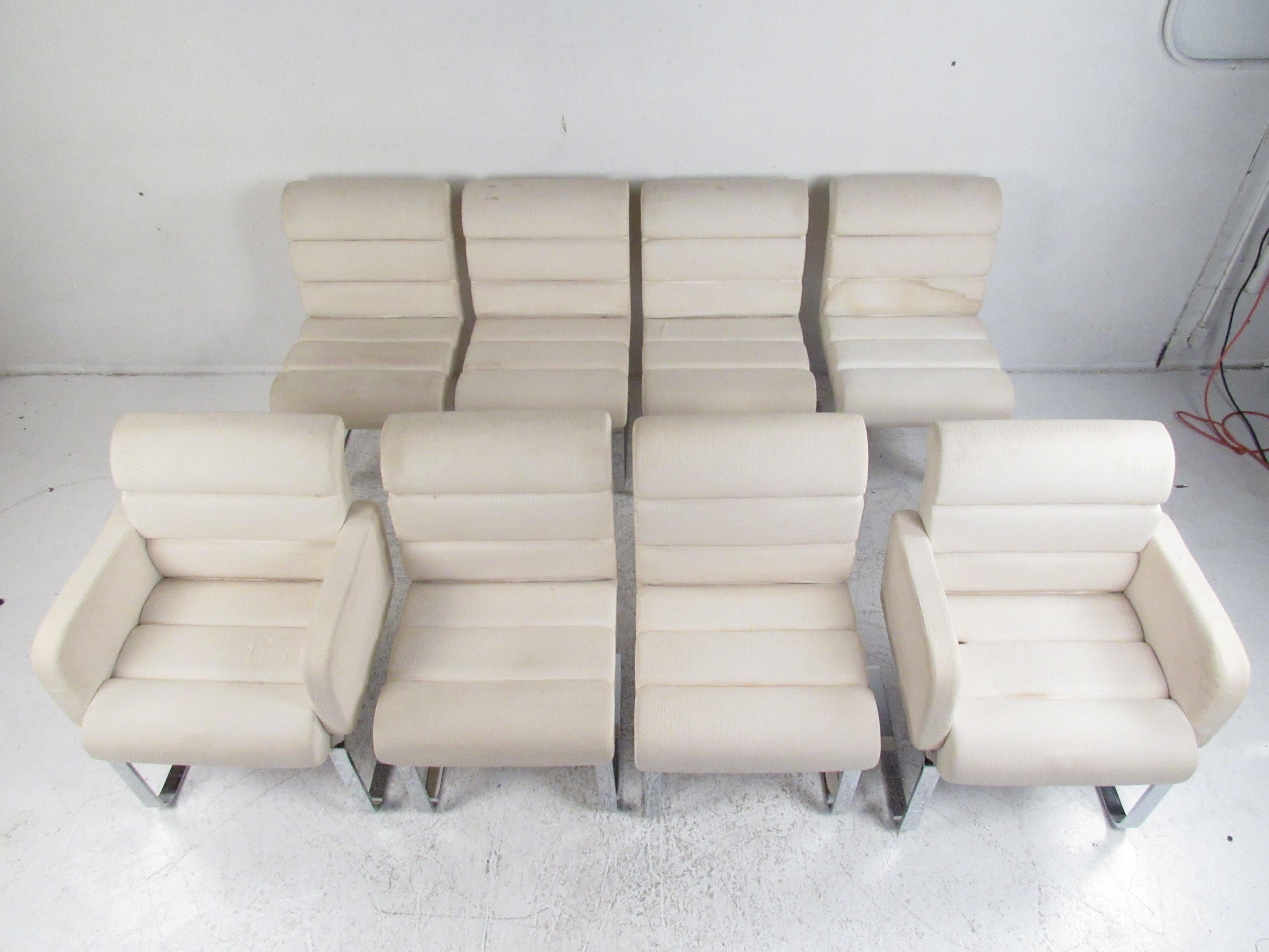 This exquisite set of eight vintage modern Italian dining chairs boast a cantilever design with a heavy flat bar chrome frame. A sleek set that includes two arm chairs and six slipper dining chairs, The thick padded seats are covered in a plush