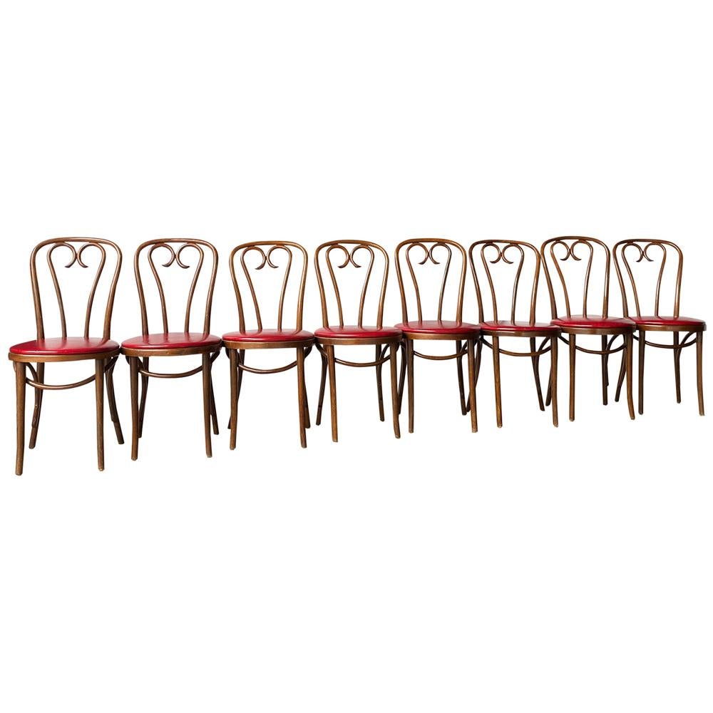 A complete set of 8 vintage dining chairs made in Poland c.1950's. They feature bentwood frames with red naugahyde seat cushion. Nice vintage condition and ready to use.