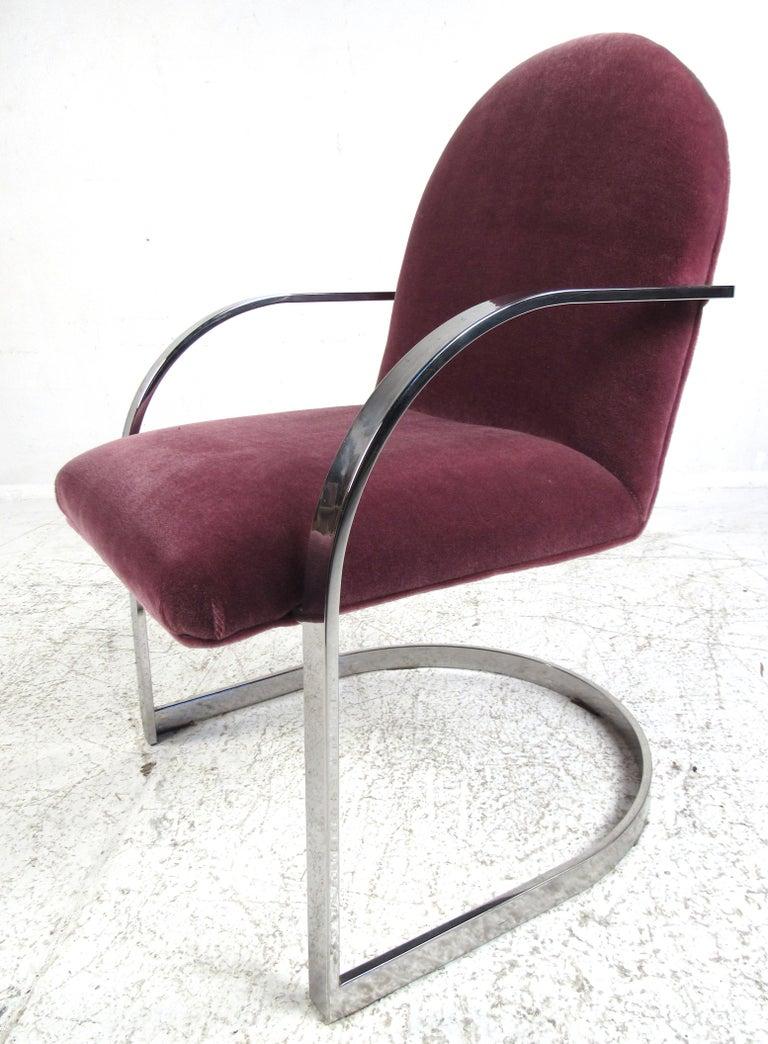 This set of 1970s vintage Milo Baughman chairs feature heavyweight polished stainless steel frames and plush velour upholstery. A truly classic design that will easily fit into any contemporary home or office environment. Please confirm item