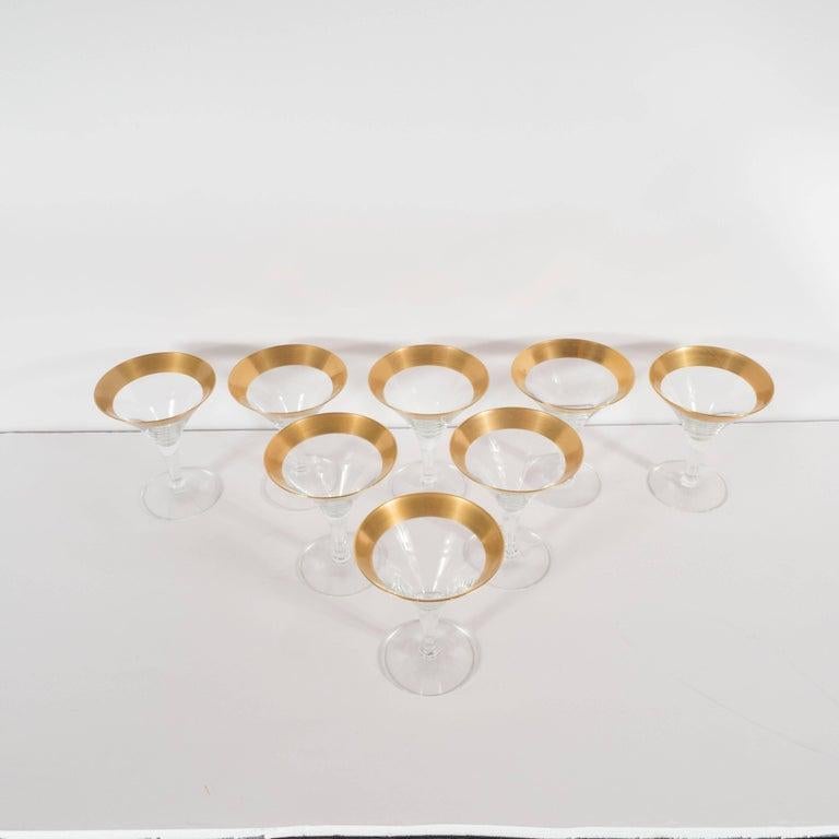 This elegant set of eight champagne glasses/martini glasses were realized by the esteemed Mid-Century Modern designer, Dorothy Thorpe, circa 1945. They feature 24-karat gold rims- an exceptionally rare and sought after edition of this iconic glasses
