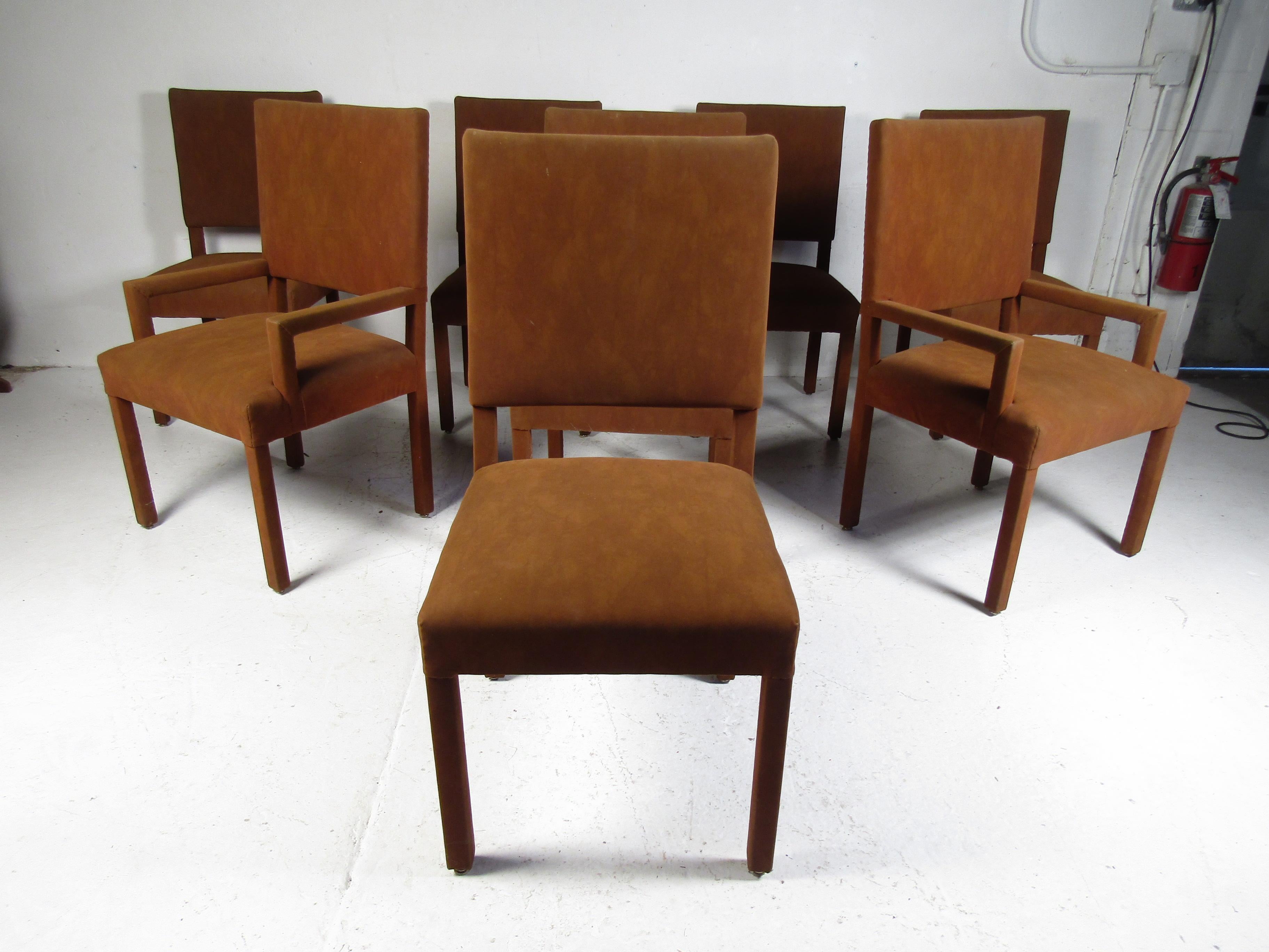 This stunning set of eight vintage modern dining chairs feature suede upholstery and thick padded seating. A sleek and comfortable design that is sure to complement any modern interior. Please confirm item location (NY or NJ).