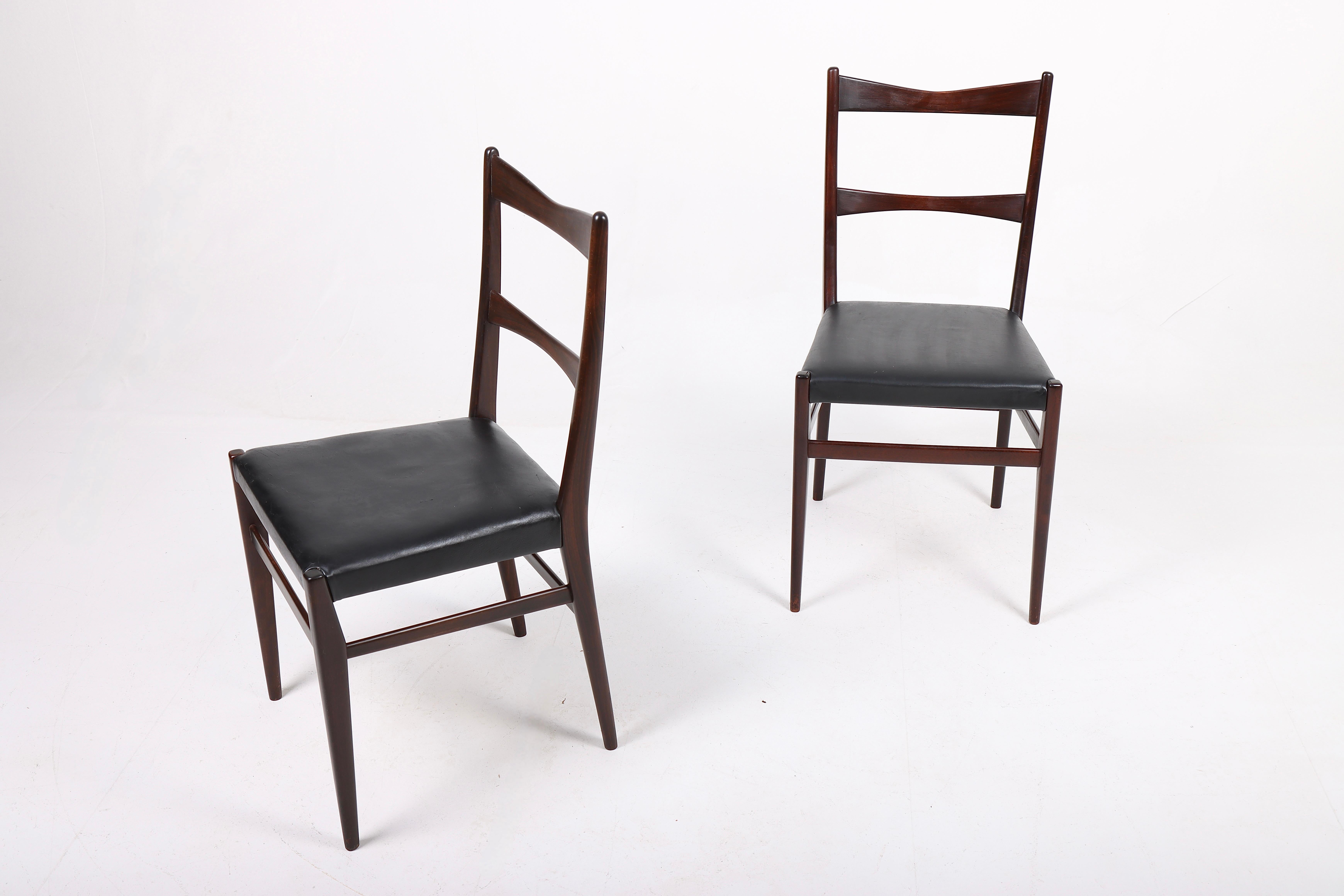 Set of eight side chairs in beech and black leather. Designed and made in Italy. Great original condition.