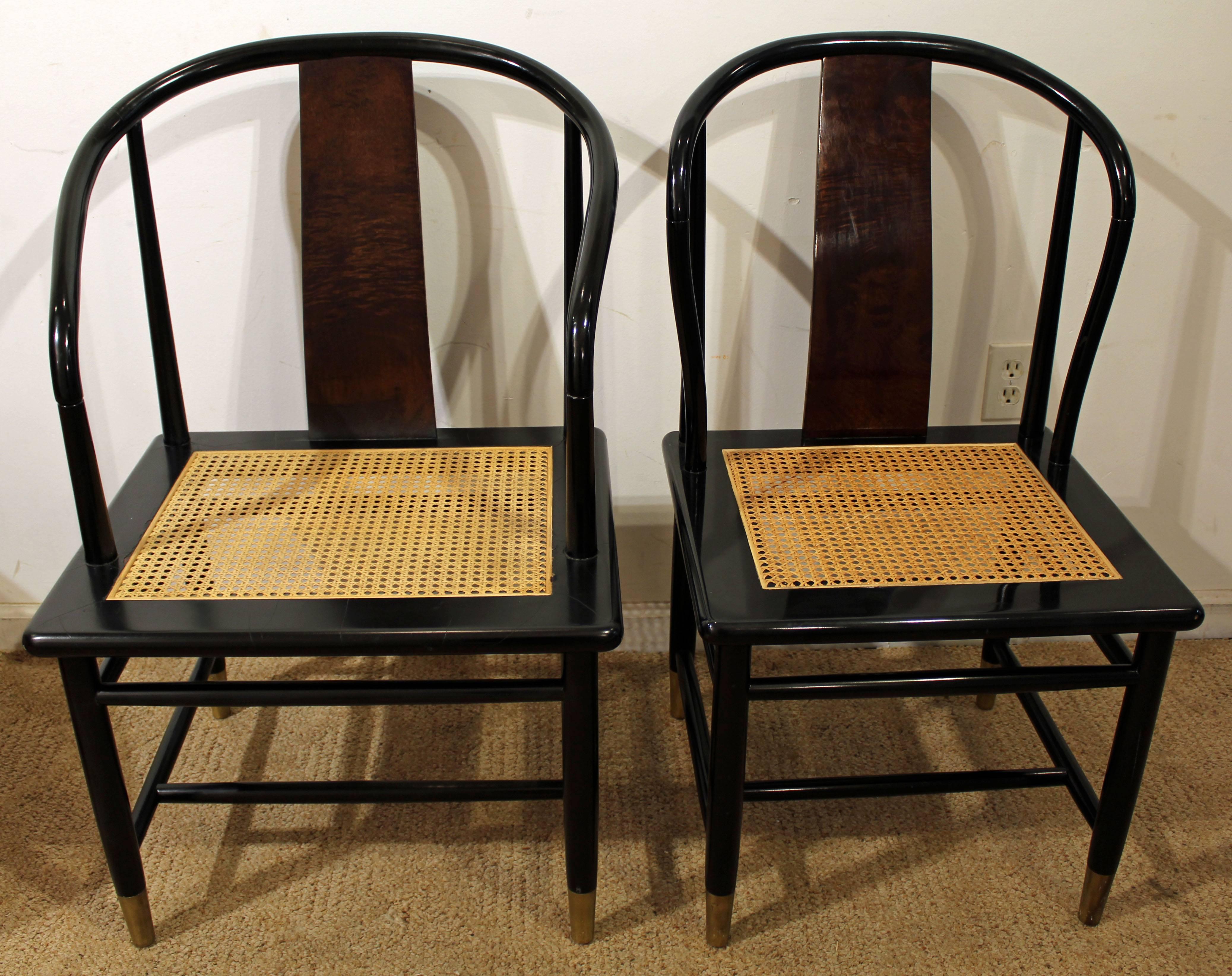 Offered is a set of eight midcentury Asian dining chairs designed by Leona Herman for Henredon. They feature black lacquer frames with lacquered burl wood backs, brass feet, and caned seats. Includes two armchair and six side chairs. They are signed