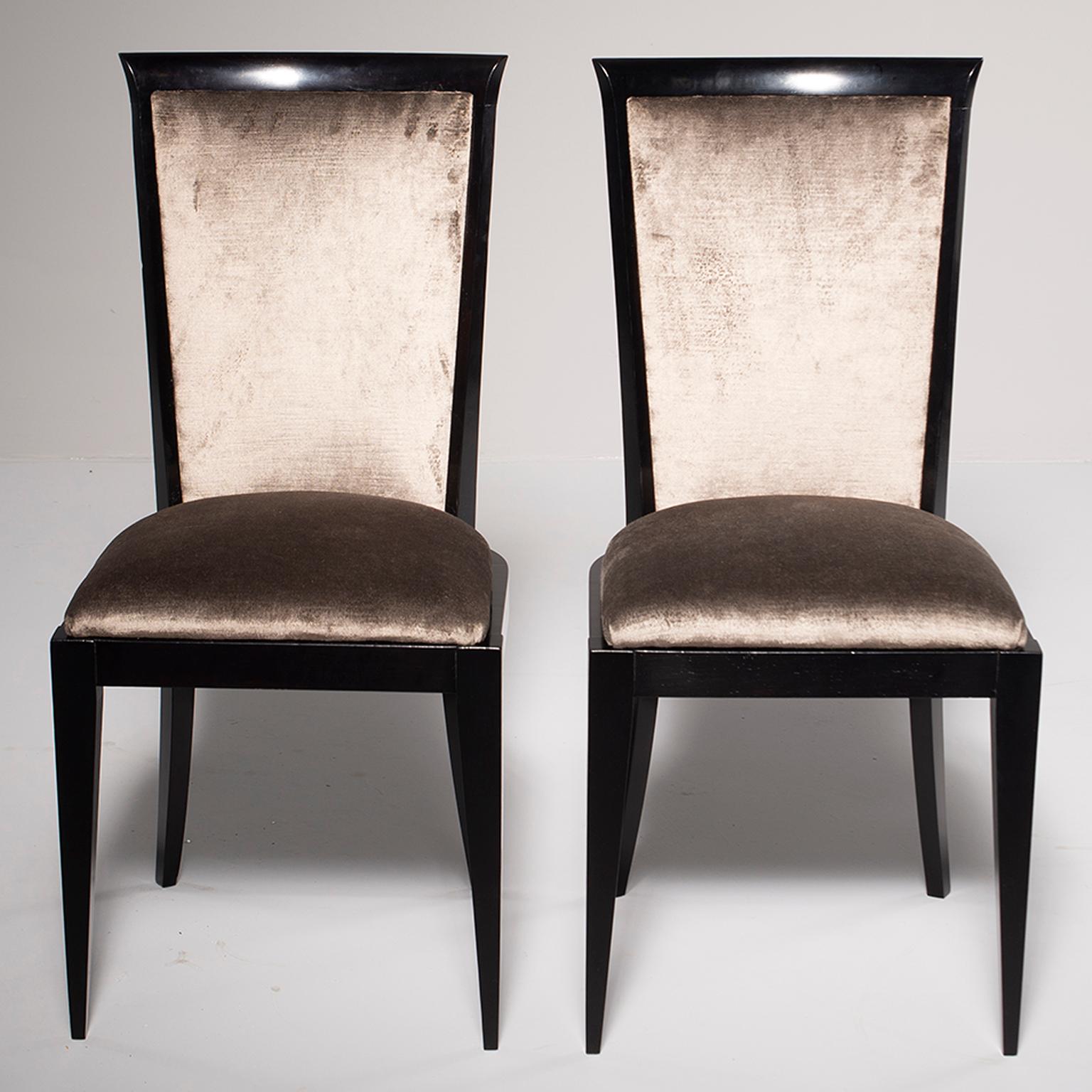 This set of circa 1960s eight dining chairs had a new ebonized finish professionally applied in England and have been reupholstered in a medium taupe colored chenille velvet. The fabric has a bit of sheen and the frames have subtle, elegant curves