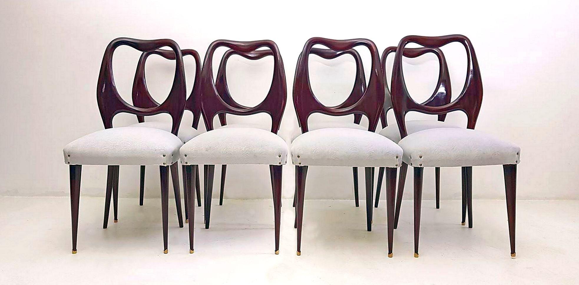 A set of eight Italian mahogany dining chairs with a superb organic design in mahogany by Vittorio Dassi. Professionally restored and reupholstered in a pale slightly patterned gray velvet. The chairs have supreme craftsmanship and are in excellent