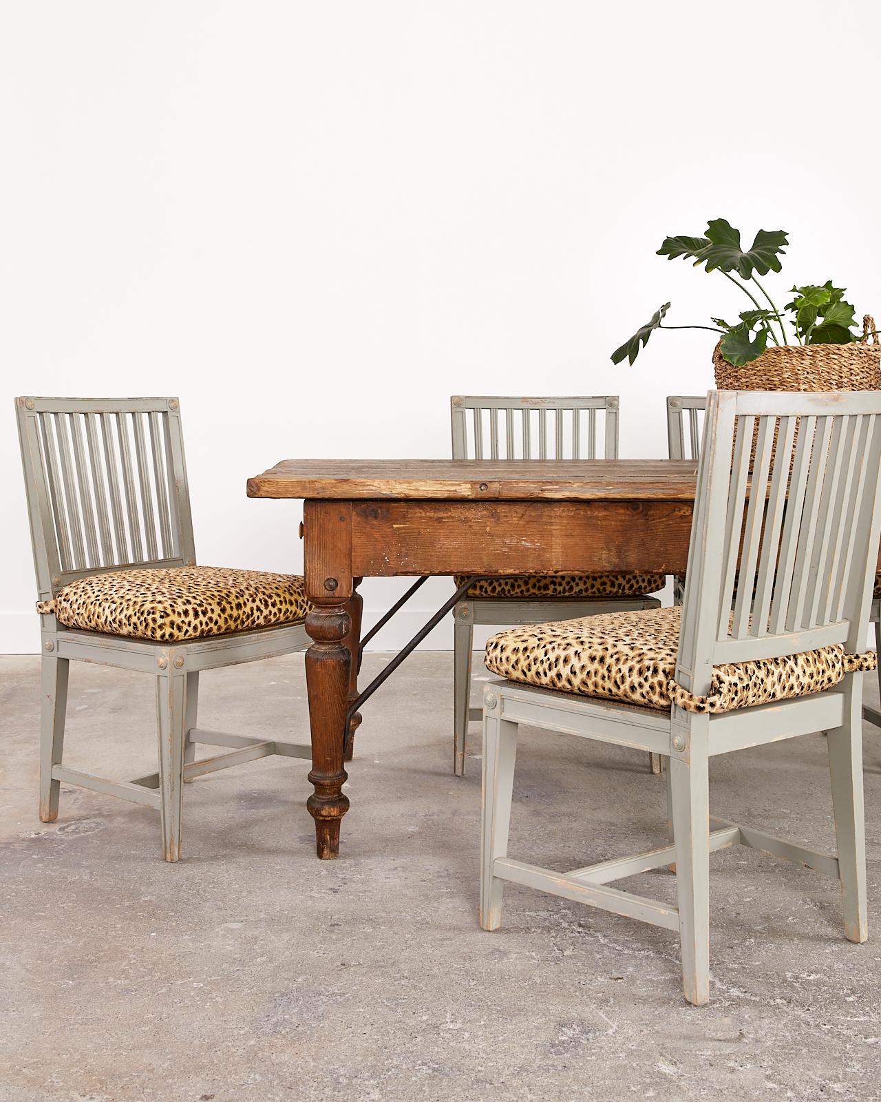 Distinctive set of eight Mid-Century Modern dining chairs featuring a neoclassical style square slat back design. The chairs have an intentionally aged, distressed painted patina by Rachel Ashwell with makers plaque on bottoms of seat. The seats