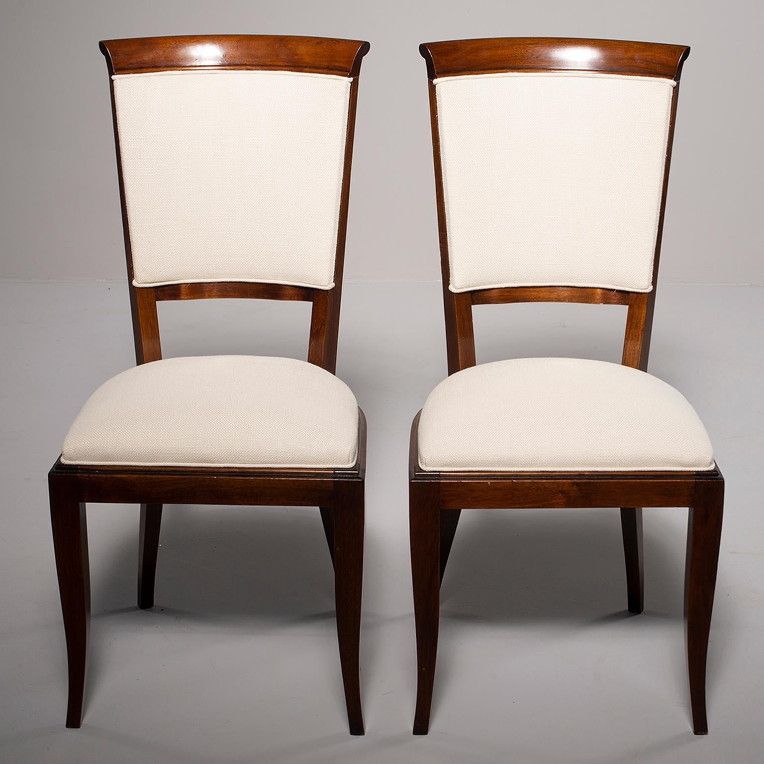 Set of dark stained beech chairs found in Italy, circa 1950s. We had the frames professionally polished in England and the seats and backs have been reupholstered in an off-white dobby woven linen blend fabric. Seats are 20” high and 16” deep. Sold