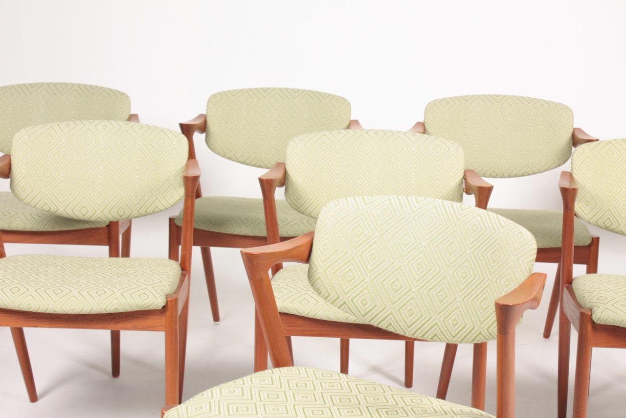 Set of eight side chairs in solid teak with fabric. Designed by Kai Kristiansen. Great condition.