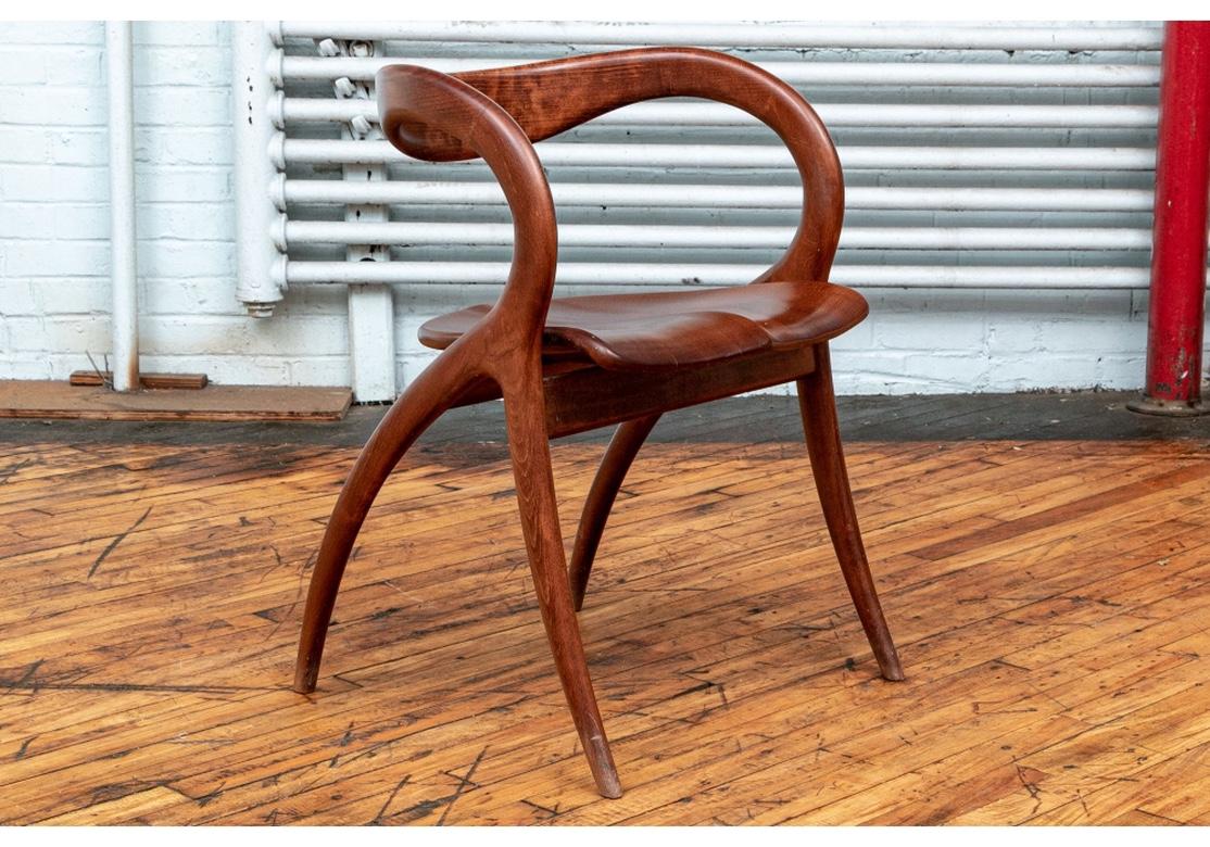 Custom made set of solid mahogany handcrafted dining or office chairs, reminiscent of the designs of Norman Cherner. Sinuous wishbone form mahogany armchairs with open curved backs and arms sloping into the tapering legs. The front legs splayed and