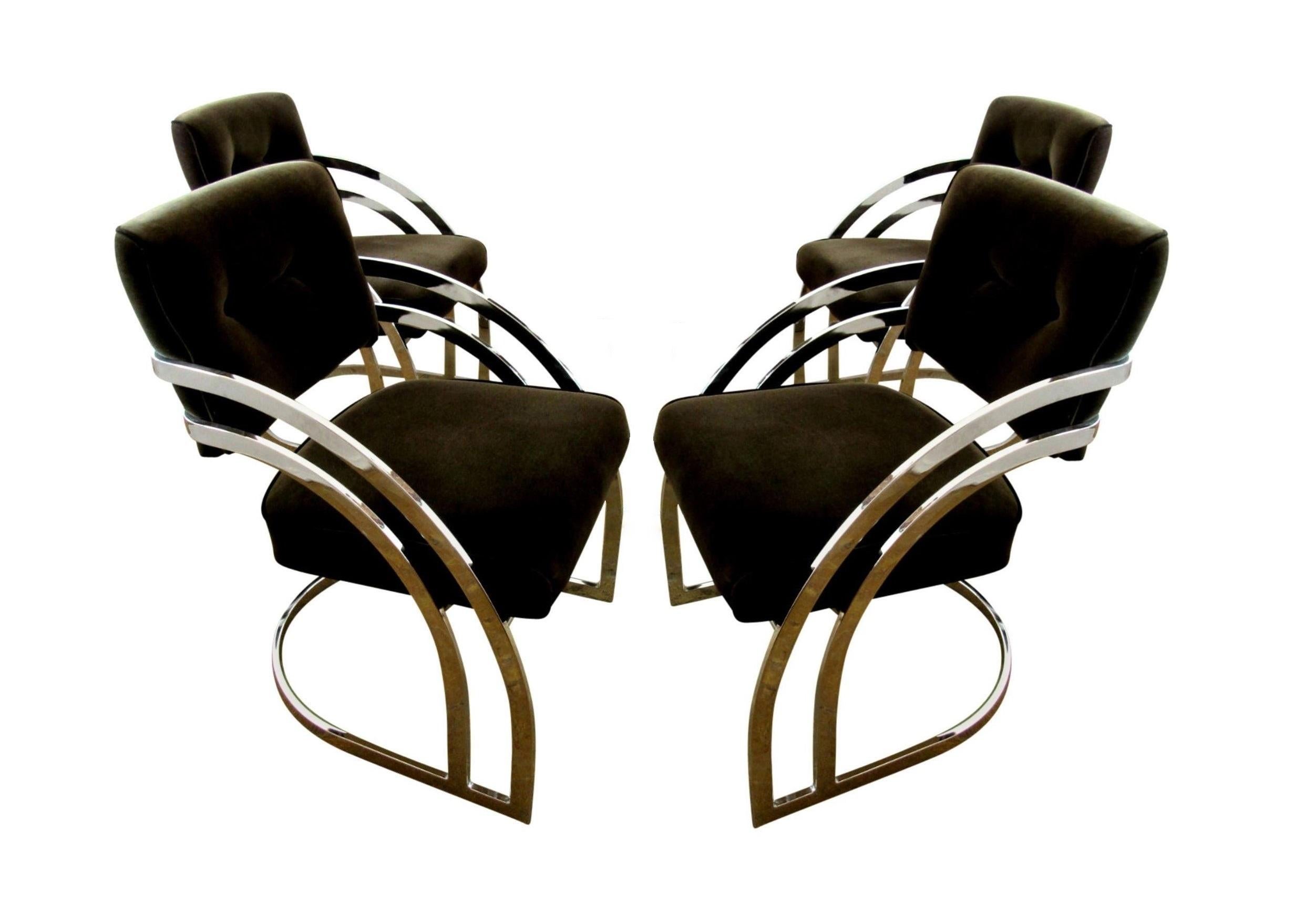Killer chrome dining chairs in the manner of Milo Baughman. Professionally upholstered in a charcoal black colored velvet fabric provides a modern vibe with its chrome frames. The chair backs have a triple bar design and waterfall cantilevered