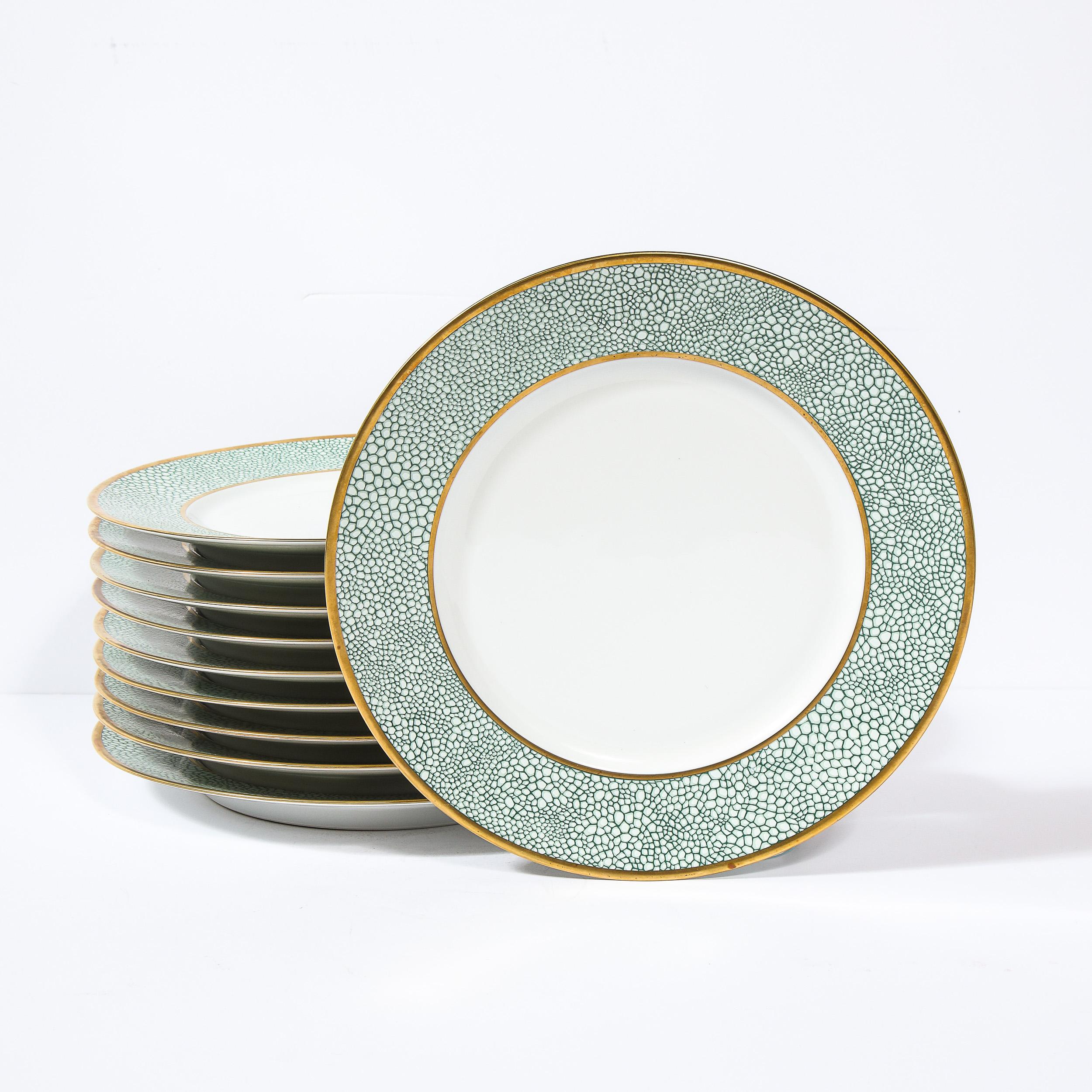 This stunning set of eight Galuchat pattern limoges porcelain dinner plates were realized by Manuel Canovas for the legendary French maker Puiforcat in France. They feature white centers circumscribed in 24kt gold with a stylized turquoise shagreen
