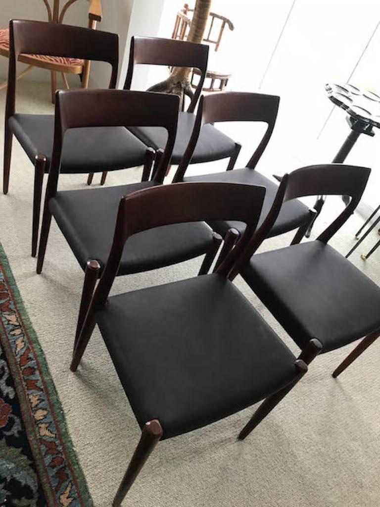 Wonderful form on these timeless dining chairs. The six sides and two arms are comfortable, and the rich wooden frames are in excellent, structurally sound condition. We have just reupholstered the chairs in a rich chocolatey brown leather, which