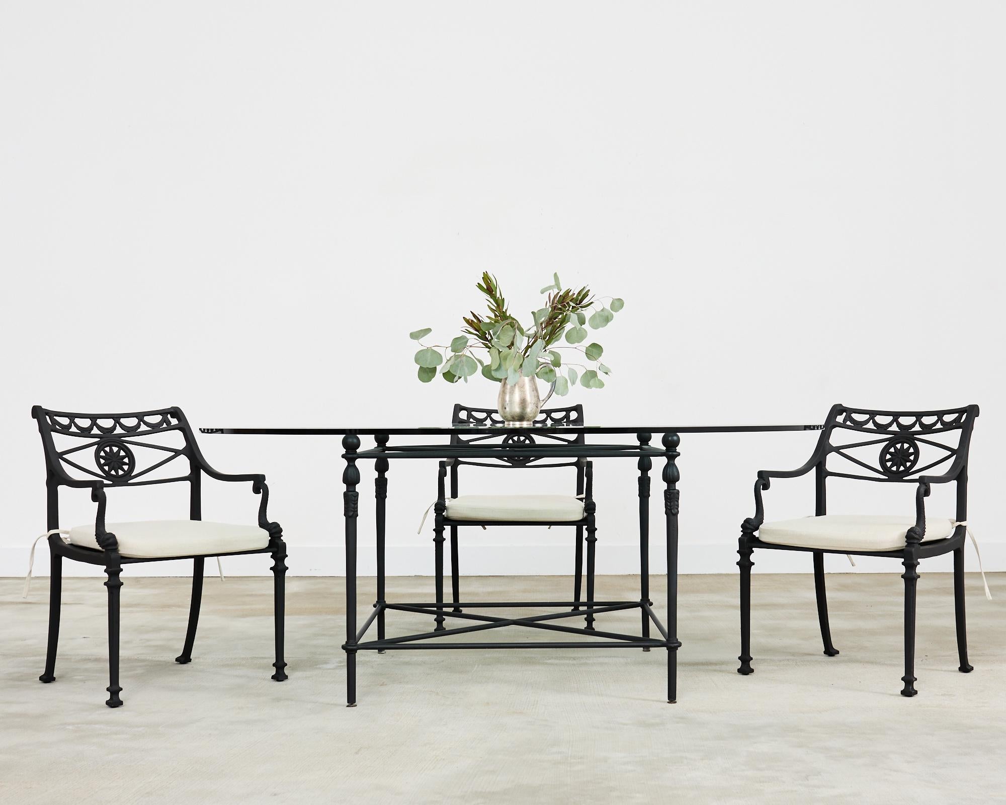 Opulent set of eight patio and garden dining armchairs attributed to Kenneth Lynch and Sons, Oxford, CT. The iconic chairs feature a neoclassical motif with a solid cast aluminum frame decorated with a sunburst star motif splat surmounted by swag.