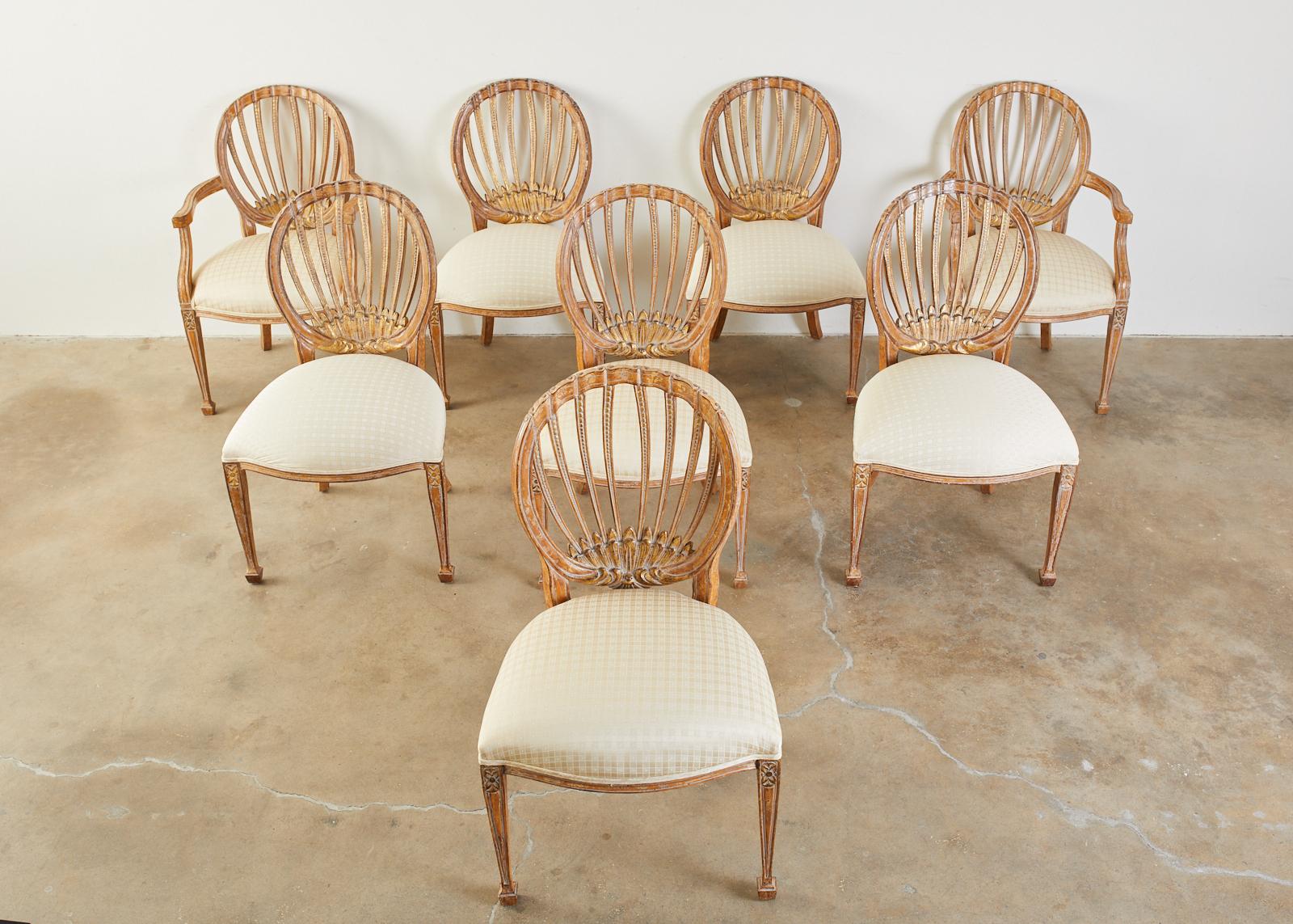 Gorgeous set of eight dining chairs by Kreiss collection West Hollywood, CA. The chairs feature a parcel-gilt intentionally distressed aged patina on the finish. The set consists of six side chairs and two armchairs measuring 24 inches wide. The