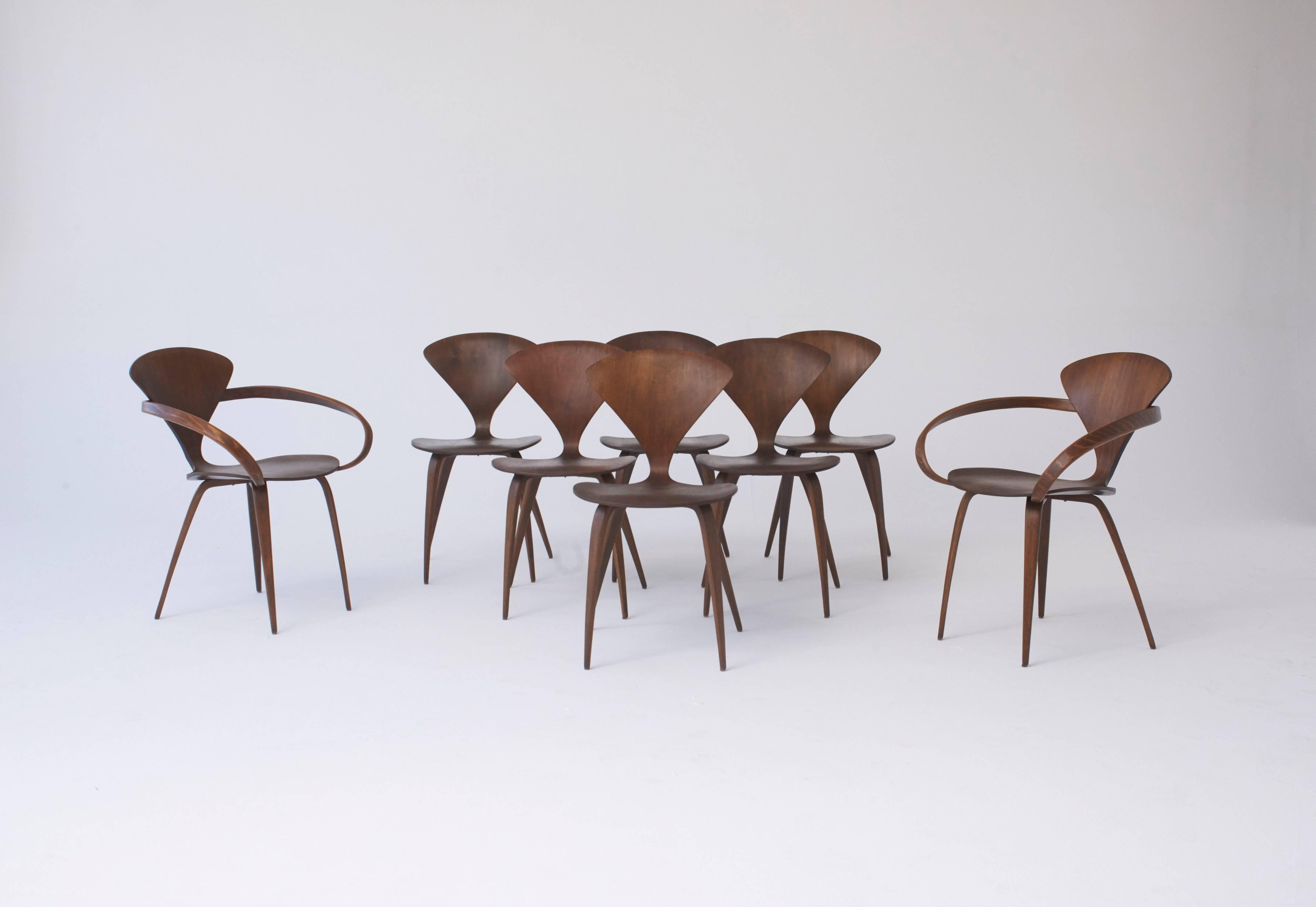 A rare full set of eight original Norman Cherner dining chairs, made by Plycraft USA in the 1960s. Six side chairs and two pretzel end chairs. Bentwood frames. Plycraft labels to the underside of all.