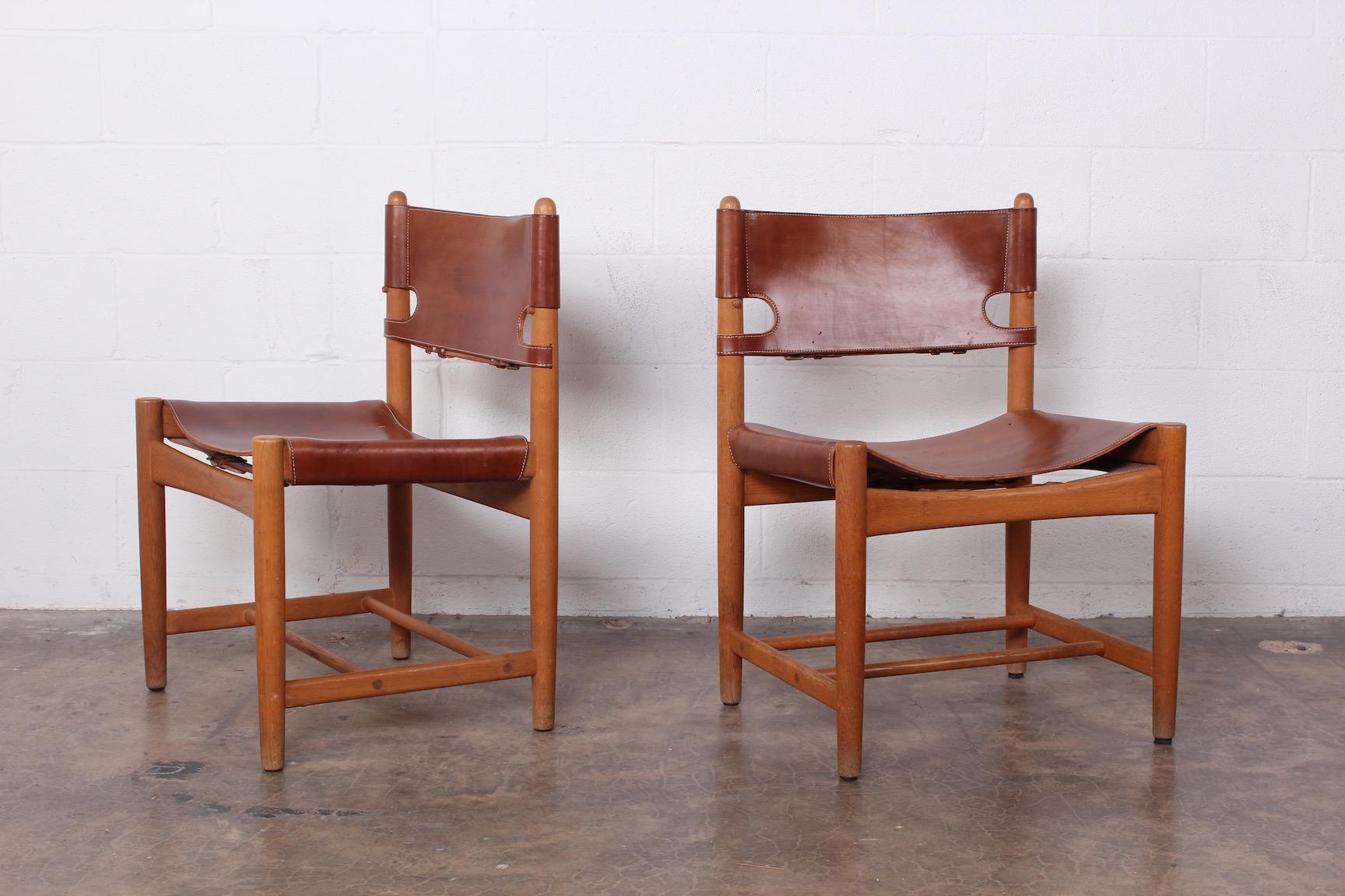 A set of six side chairs and two armchairs in oak and original patinated leather by Børge Mogensen.