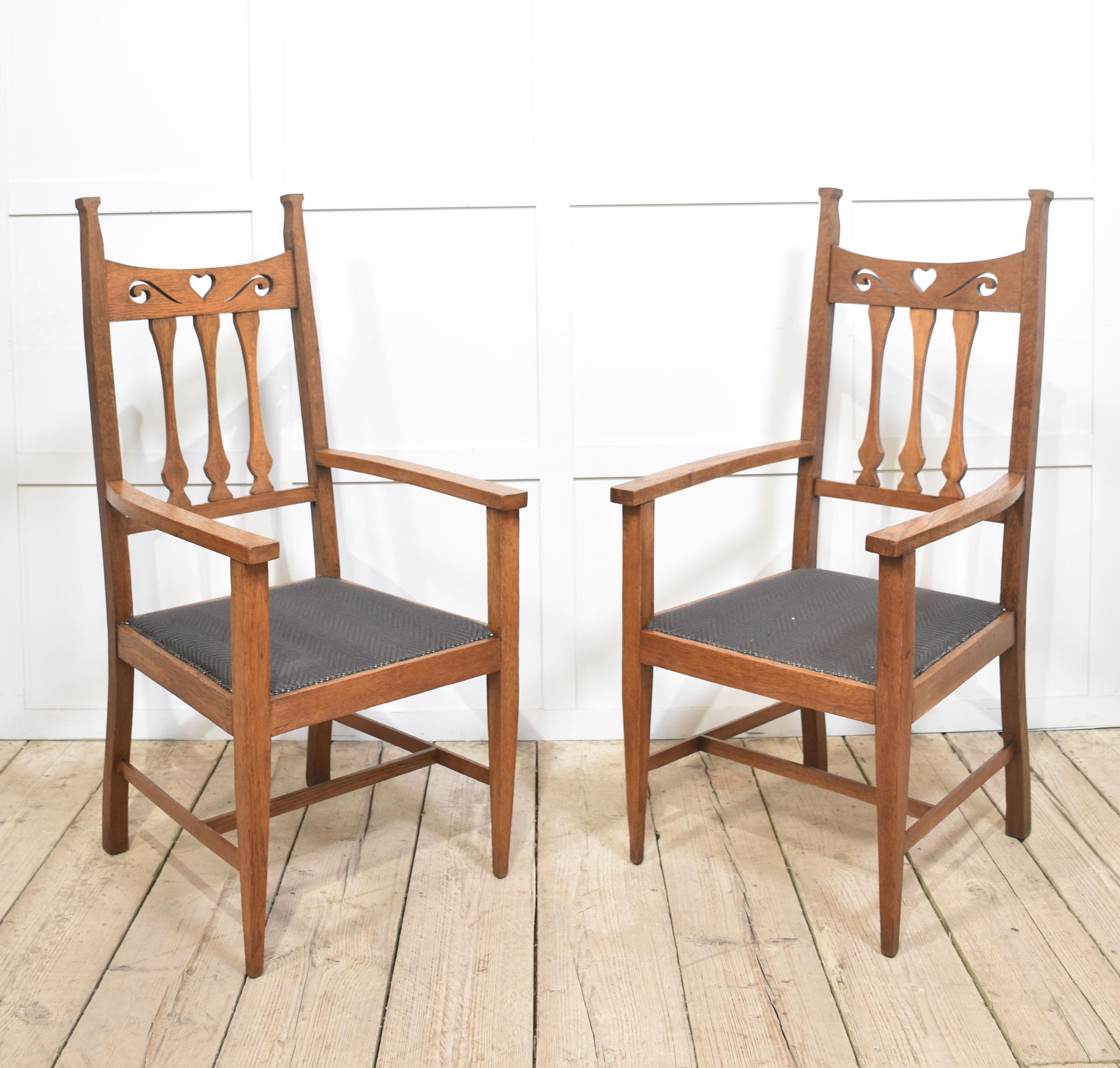 Set of eight oak Arts and Crafts dining chairs. comprising of two armchairs and six chairs, having carved top rail above splat backs, above upholstered seats, all raised up on tapering front legs united by stretchers.
Armchairs
Height 49 Inches