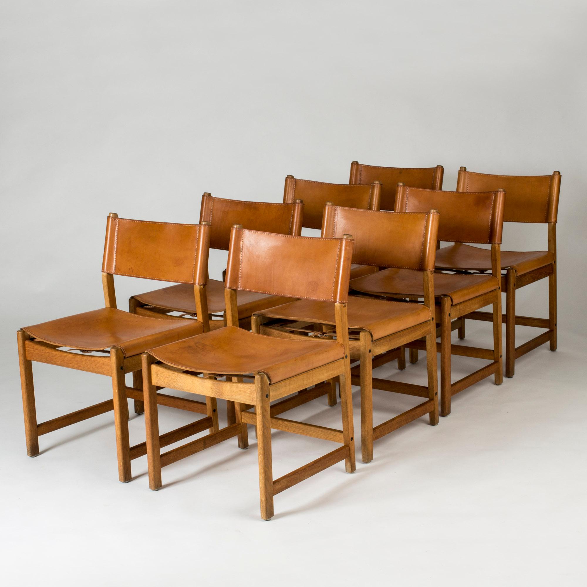 Set of eight amazing dining chairs by Kurt Østervig, with boxy oak silhouettes and leather seats and backs. Details of white seams on the sturdy, nicely patinated leather.
   
