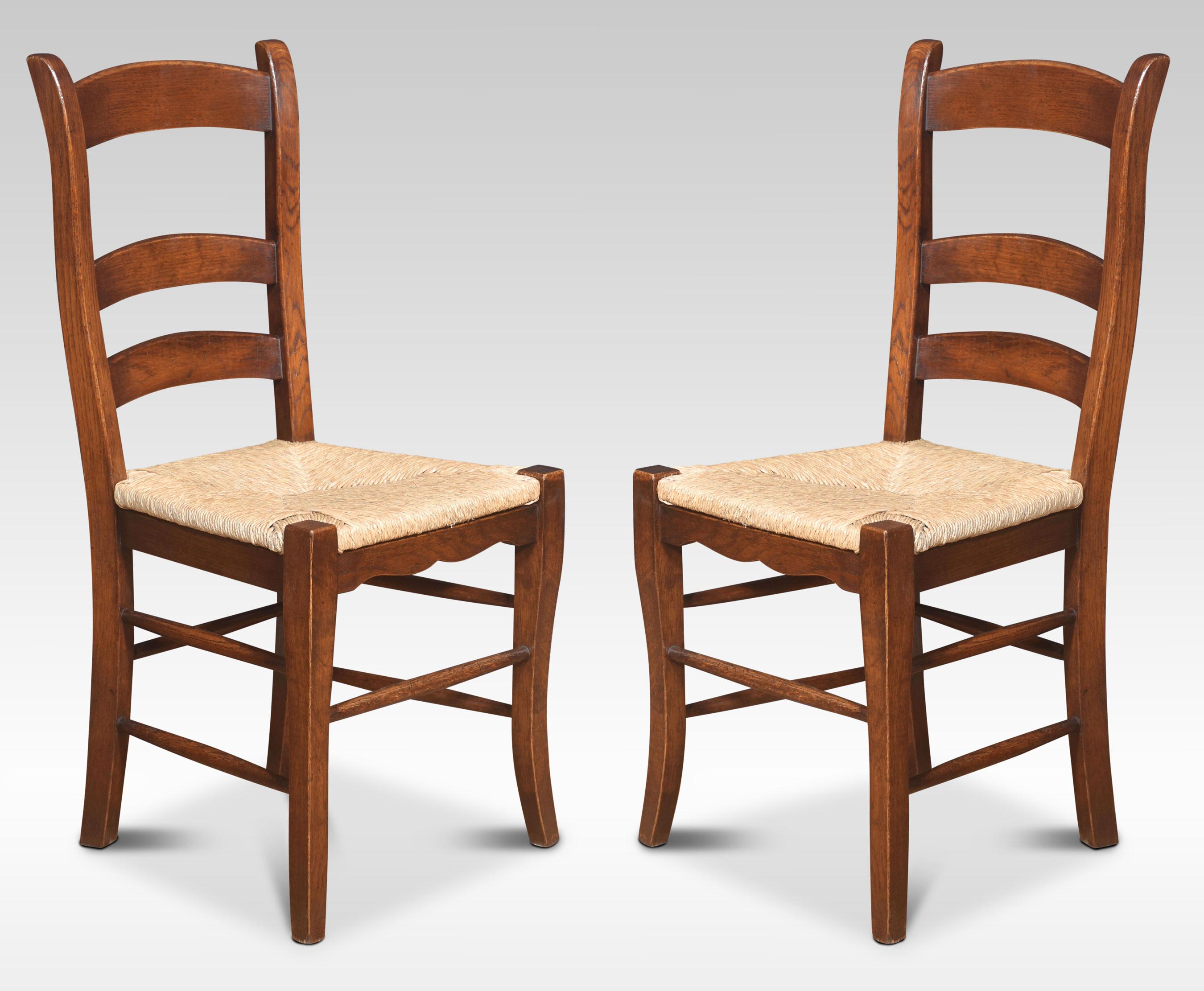 A set of eight ladder-back oak dining chairs, the ladder backs with rush seats on turned front legs united by stretchers.
Dimensions
Dimensions
Height 37 Inches height to seat 18 Inches
Width 18 Inches
Depth 17.5 Inches