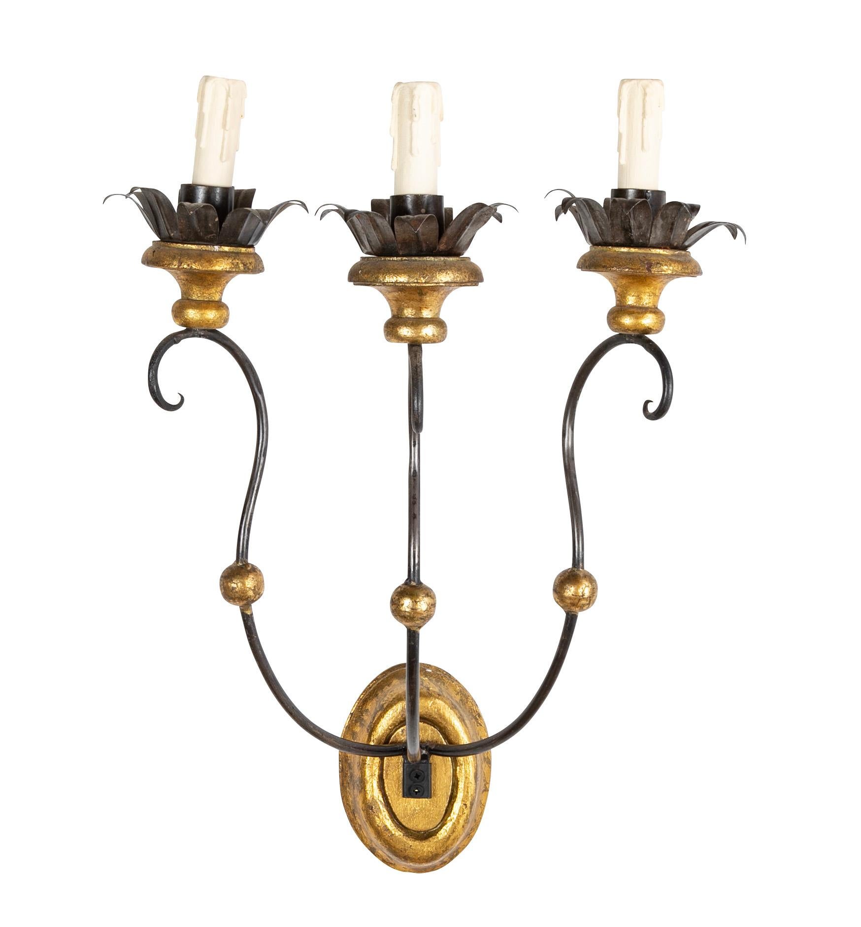 Set of eight of Italian iron tole and gilt wood sconces.  Early 20th century. 

Priced per pair.