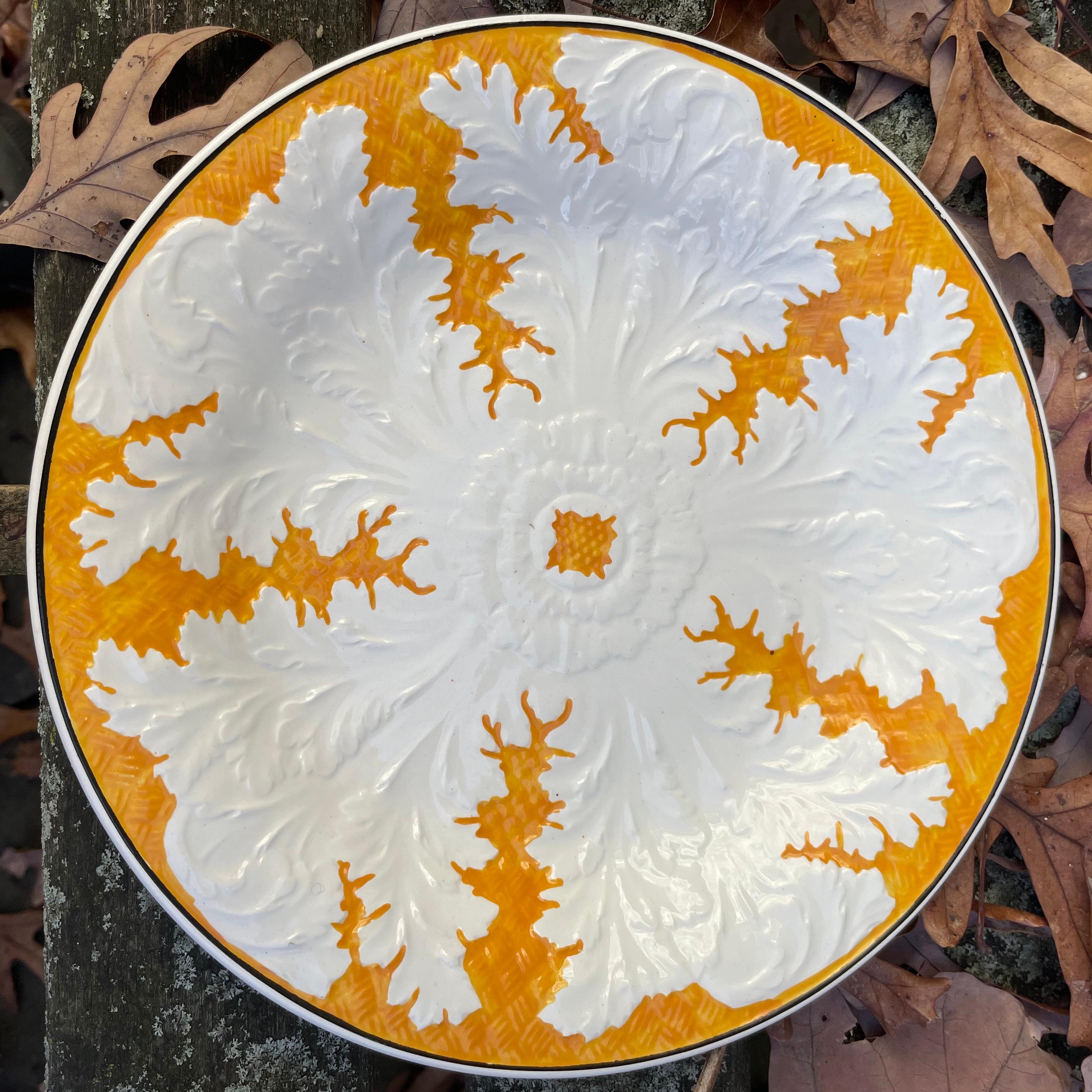 Set of eight orange and white Wedgwood cabbage plates. Eight creamware plates with molded cabbage leaves in white on orange saffron background with thin black rims. England, mid-twentieth century.
Dimensions: 9
