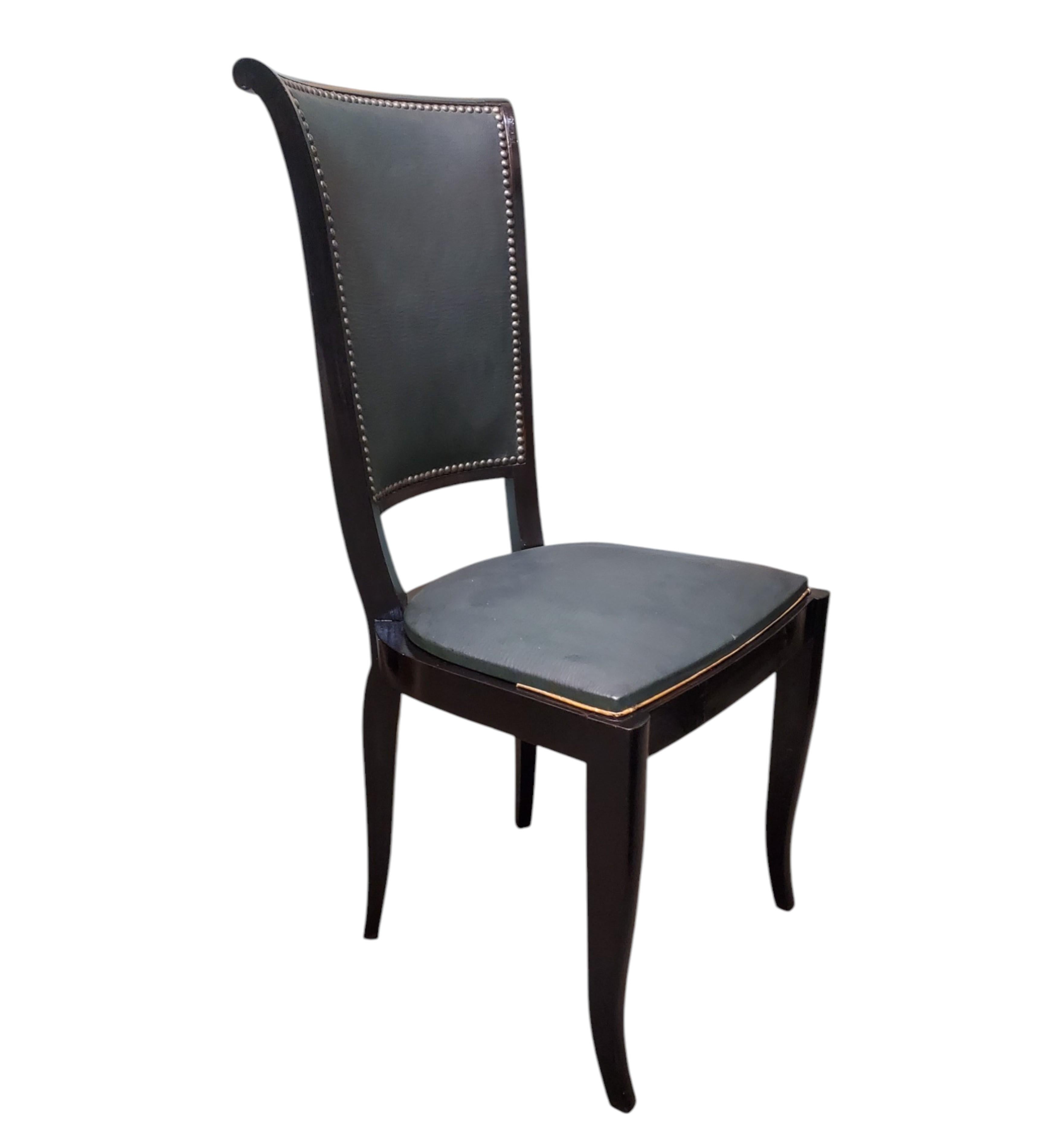 A set of eight original French Modernist / Art Deco dining chairs featuring 
tall elegant backs with a stepped linear top flanked with scroll, curled ends and ending in tapered shapely legs, branded Saint Etienne, manufactured by M.F. a French