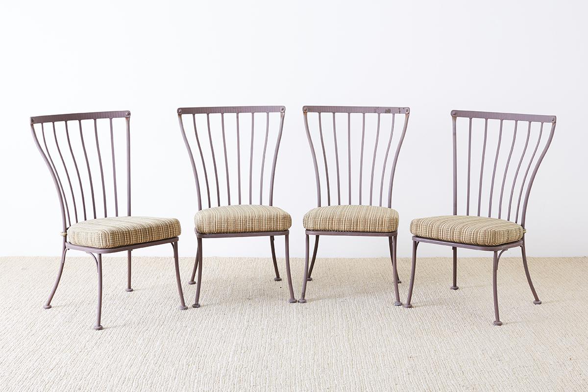 Large set of eight patio garden dining chairs made by California artisans O.W. Lee Monterra collection which features hand-hammered finishes made from galvanized steel. Set consists of four armchairs and four side chairs. Part of a large collection