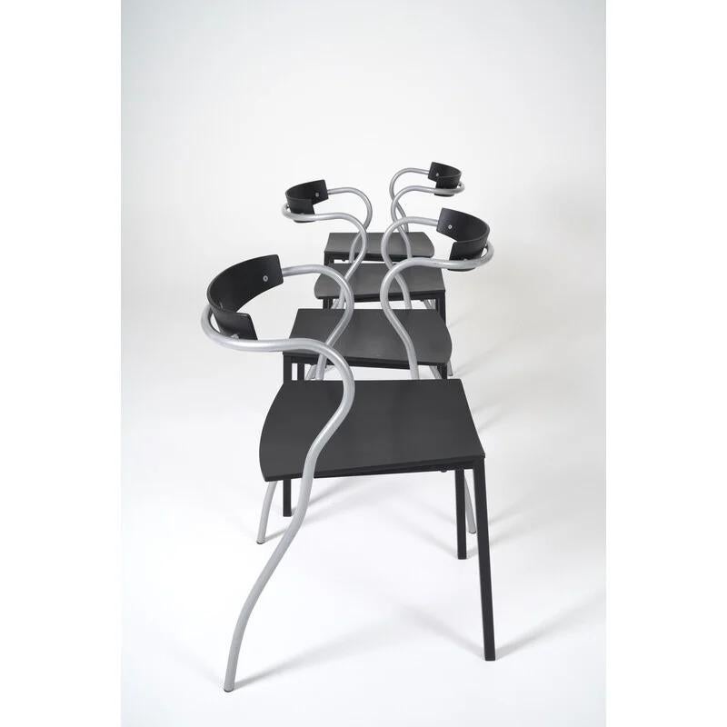 A set of eight stackable chairs designed by Pascal Mourgue and manufactured by Artelano in Paris in the early 1990s. Simple and understated yet curvy and sexy, the Rio chairs are made of black enameled curved plywood and curvy tubular metal frames.