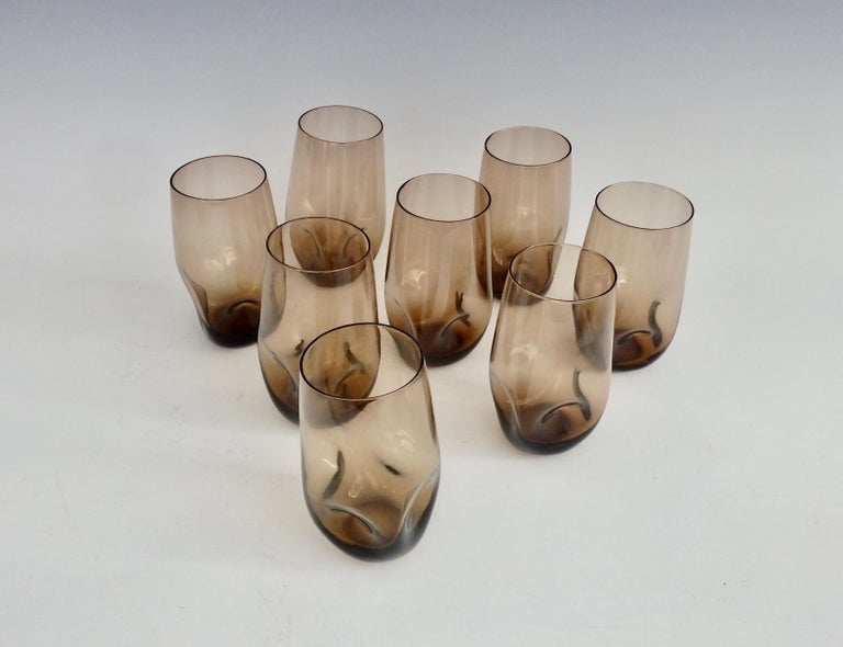 Eight cocktail glasses in curved form with dimpled bases.