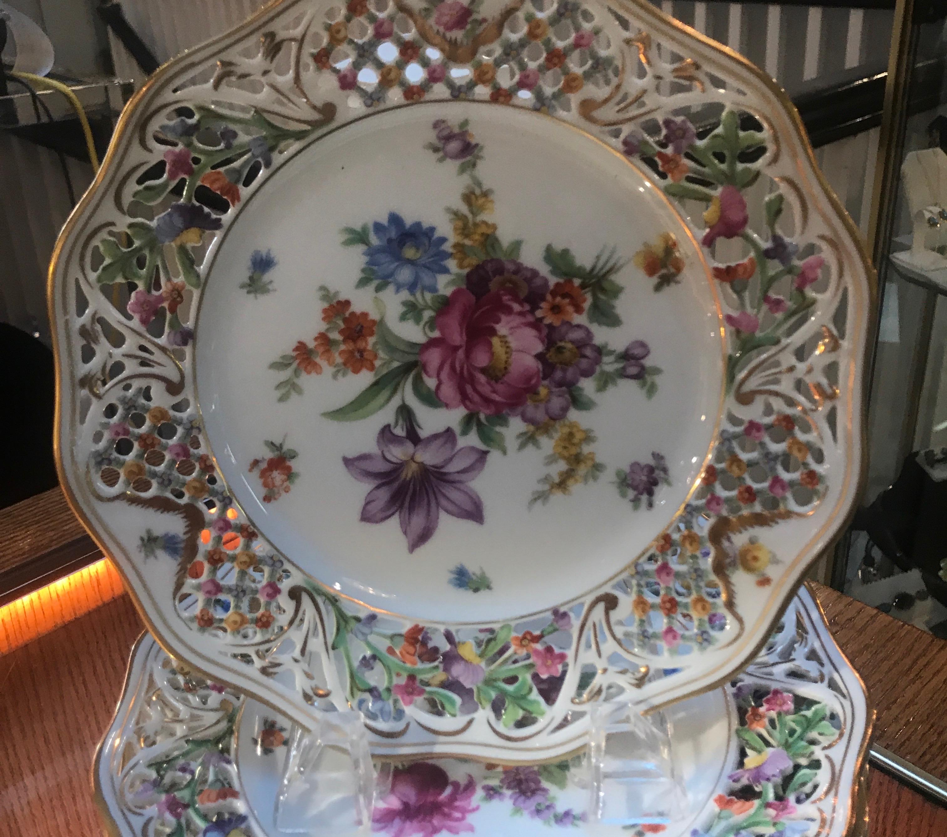 A set of 8.5 inch diameter Schumann Dresden floral luncheon plates. The reticulated borders with floral decoration with a large central bouquet. Each one with a different floral pattern. this is for the entire SET OF EIGHT....