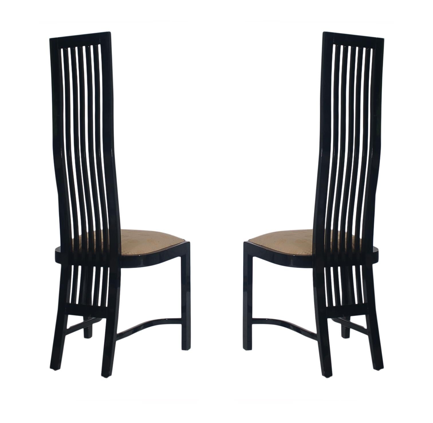 A dramatic set of 8 matching dining chairs that were produced in Spain in the late 1980s. They feature solid wood construction with gloss black lacquer. Seat cushion have some minor soiling and could use updating. Otherwise, in very good condition.