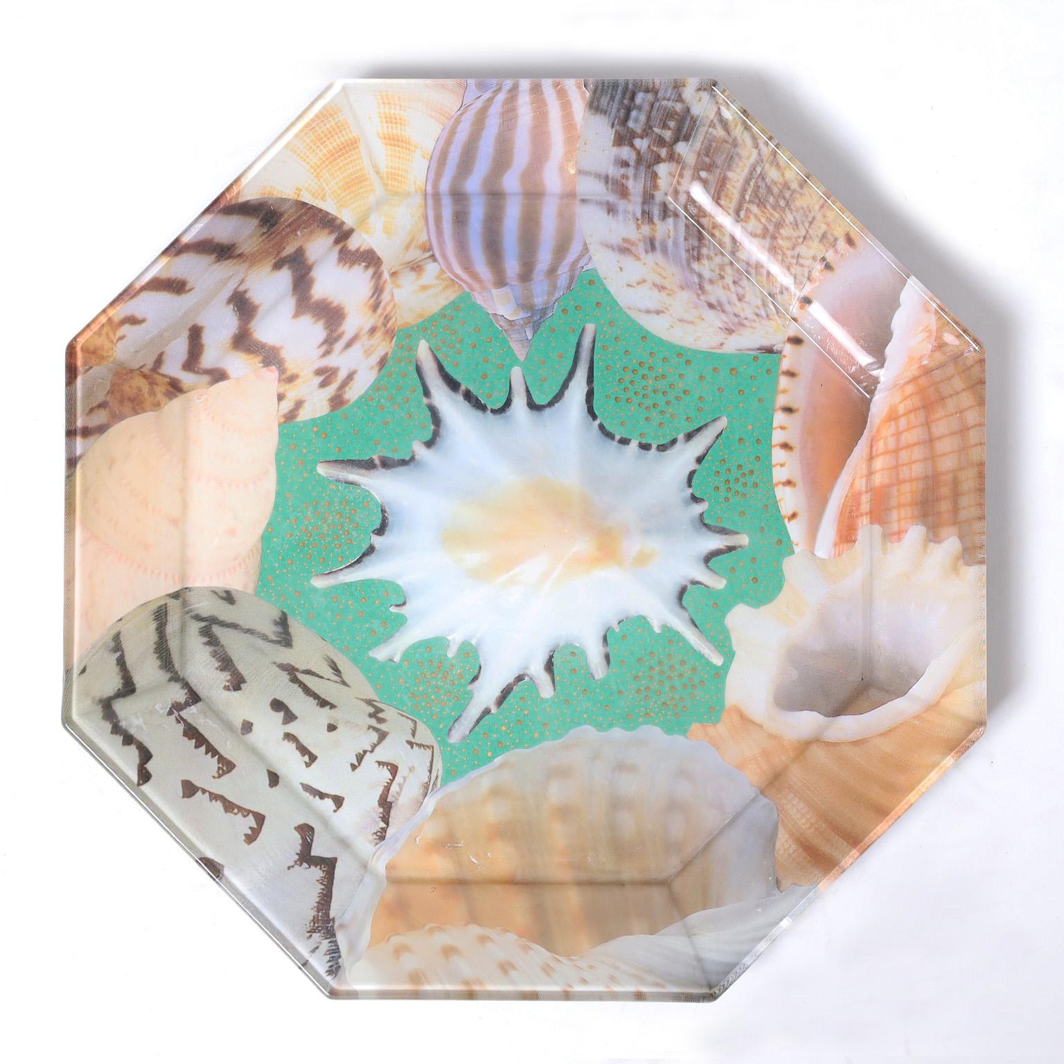 Standout set of eight glass plates with an octagon form decorated with seashells in a whimsical reverse decoupage technique. Signed Pablo Manzoni on the backs. 