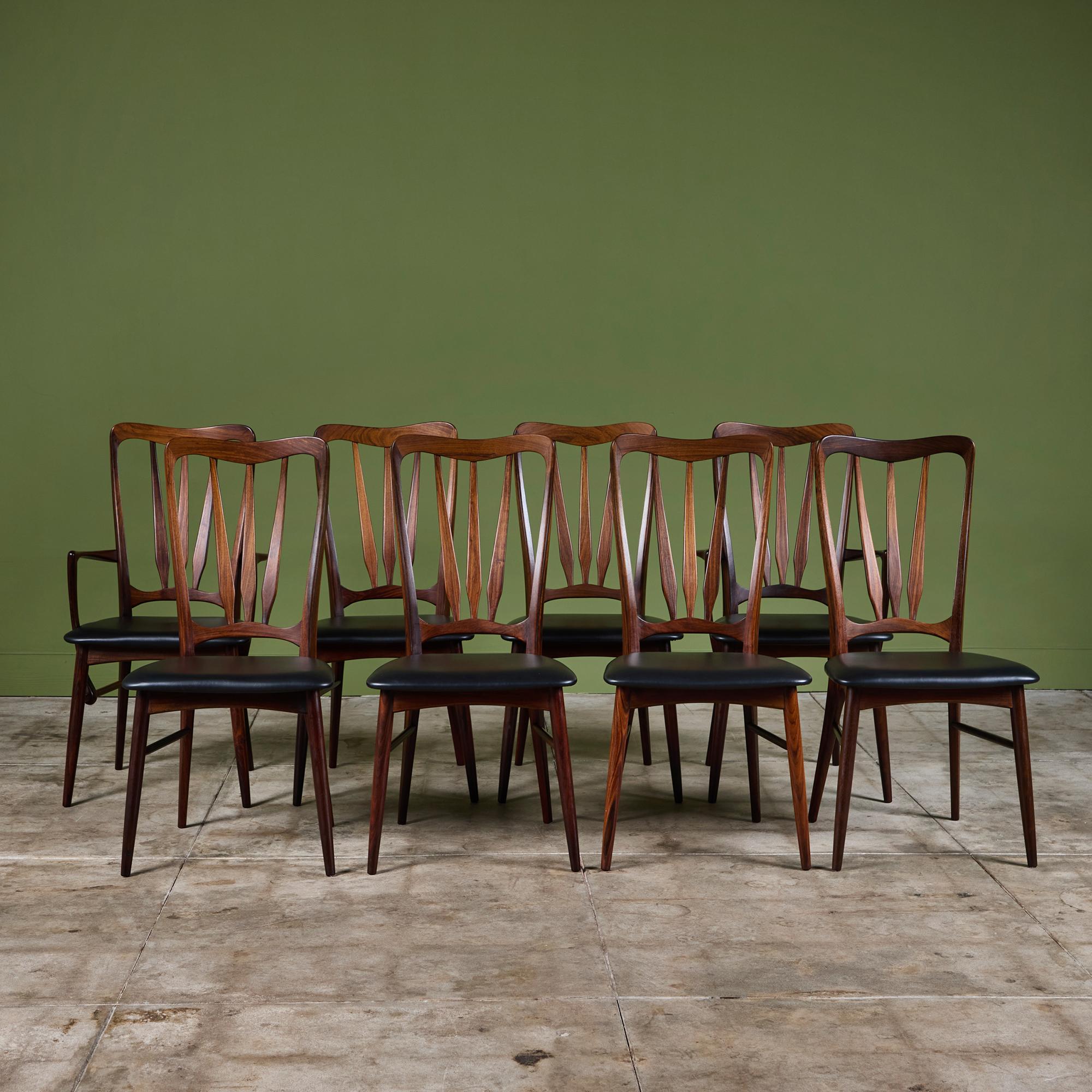 Set of eight Niels Koefoed “Ingrid” dining chairs in rosewood, c.1960s, Denmark for Koefoeds Hornslet. The set consists of six side chairs and two armchairs. All chairs feature sculpted rosewood frames with black Naugahyde seats. The armchairs have